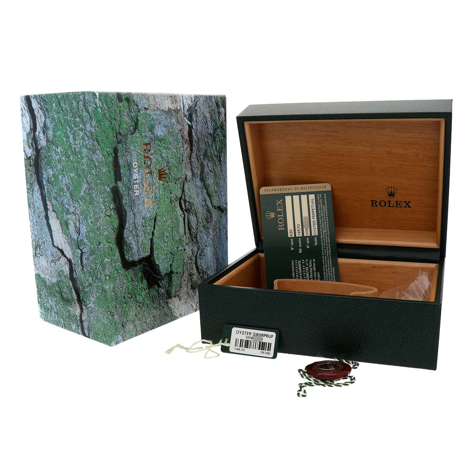 The image shows the packaging and accessories for a Rolex Explorer 16570 Men's Stainless Steel Black Dial, including an open watch box, a card, and tags.