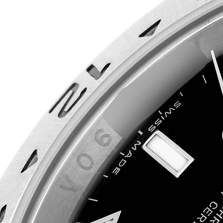 The image shows a close-up of the Rolex Explorer 16570 Men's Stainless Steel Black Dial watch dial, focusing on the bezel, partial text, and the "SWISS MADE" inscription.