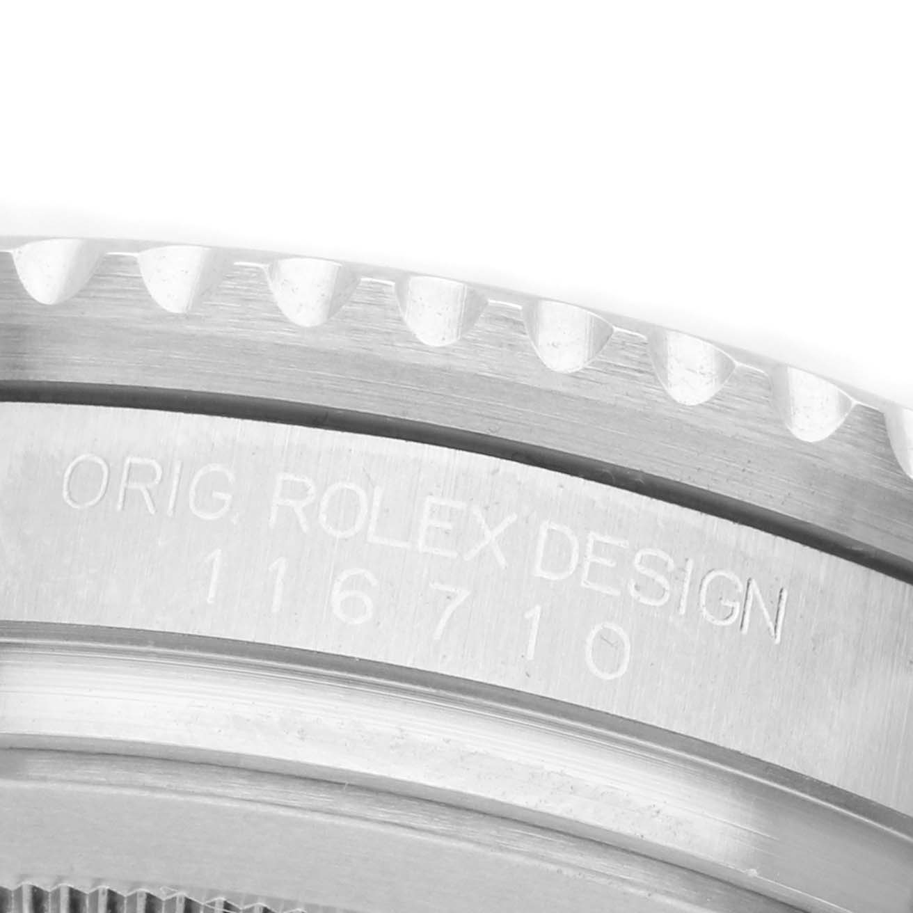 The image shows a close-up of the engraved side of the case of a Rolex GMT-Master 116710LN Men's Stainless Steel Black Dial, focusing on the model number and notched bezel edge.