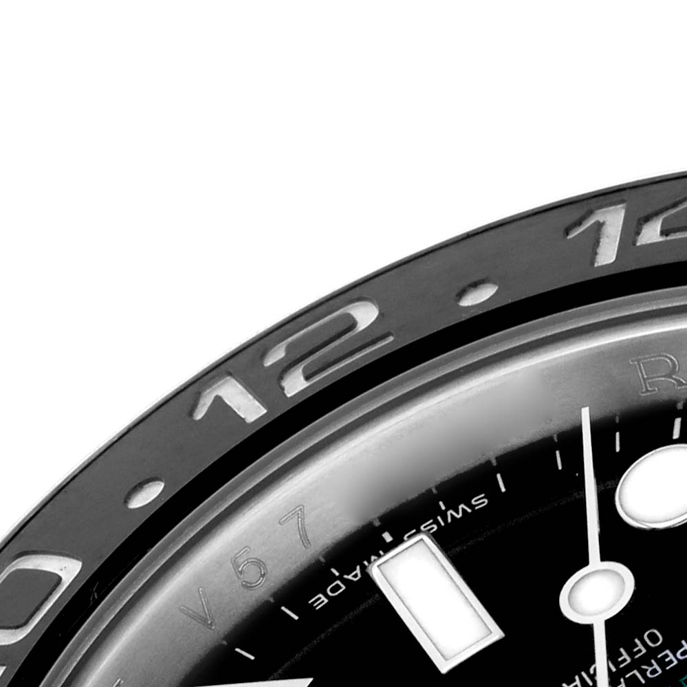 The image shows a close-up of the Rolex GMT-Master 116710LN Men's Stainless Steel Black Dial's bezel and part of the dial.