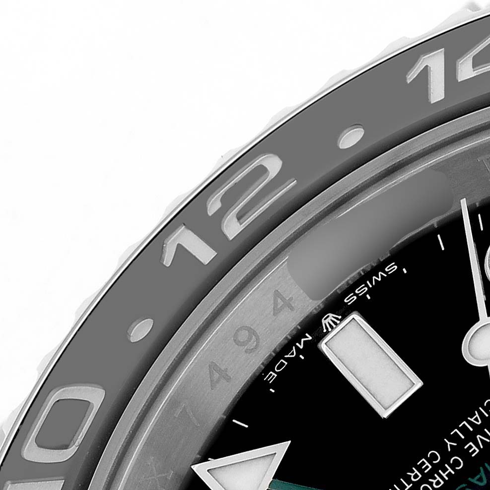 The image shows a close-up of the dial and bezel of a Rolex GMT-Master 126710GRNR Men's Stainless Steel Black Dial watch viewed at an angle from the side.