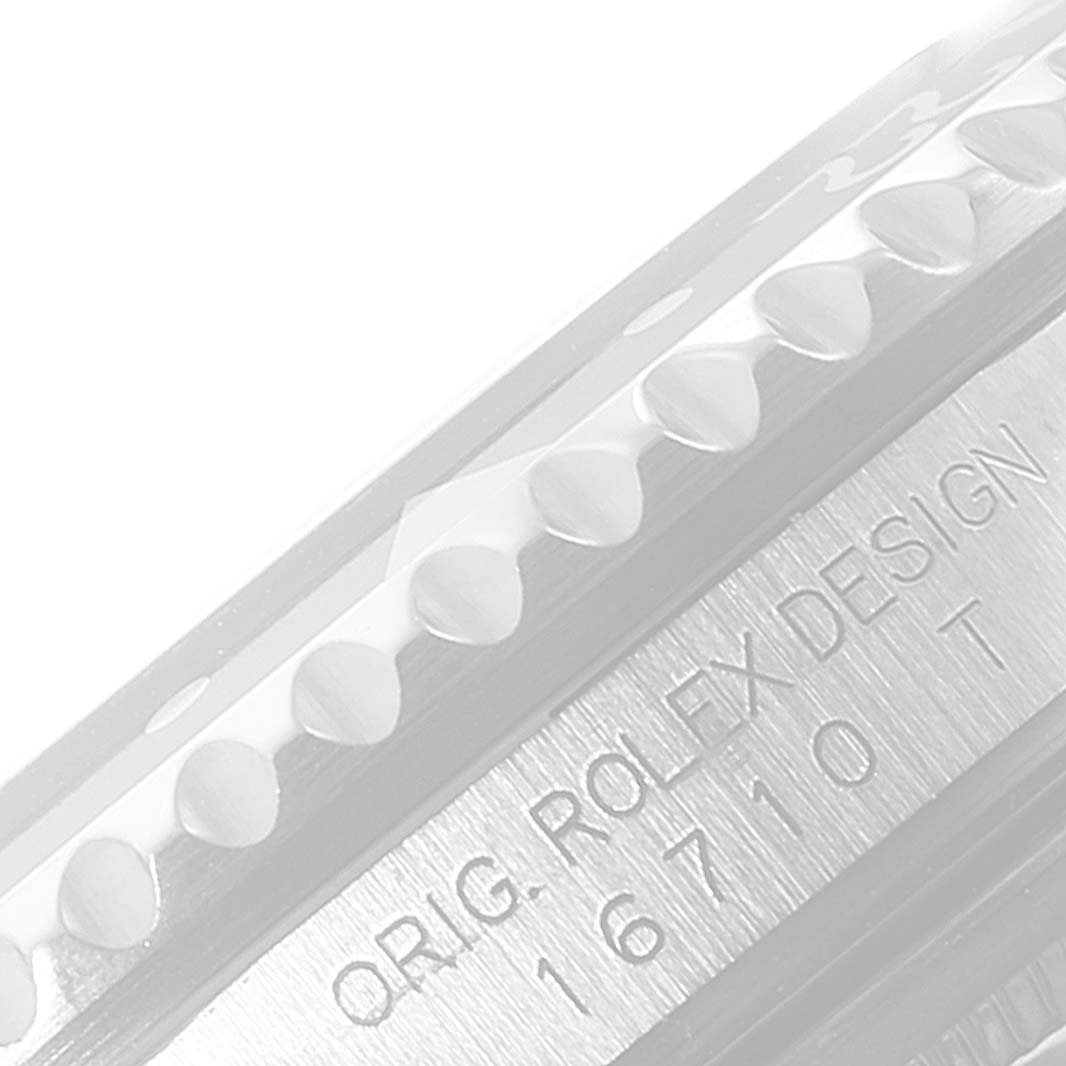 This close-up image shows the side view of a Rolex GMT-Master 16710 Men's Stainless Steel Black Dial 16710 Men's Stainless Steel Black Dial watch bezel and case, revealing the model number 16710T.