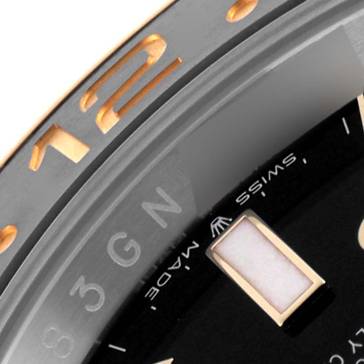 The image shows the bezel and part of the dial of a Rolex GMT-Master 126713GRNR Men's Steel and Gold (two tone) Black Dial 126713GRNR Men's Steel and Gold (two tone) Black Dial, focusing on the hour markers and part of the branding.