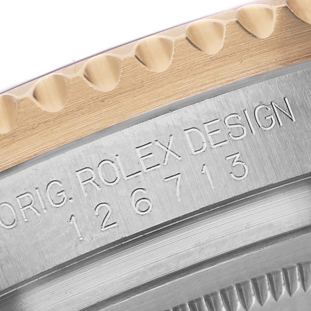 This image shows a close-up of the Rolex GMT-Master 126713GRNR Men's Stainless Steel Black Dial model's case side, focusing on the engraved model number and design details.