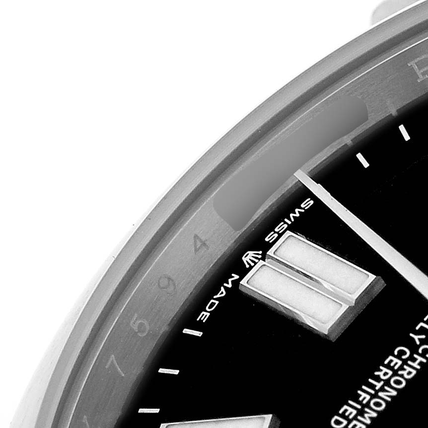The image shows a close-up of the Rolex Oyster Perpetual 7594Z726 Men's Stainless Steel Black Dial watch's dial, focusing on the hour markers and part of the bezel.