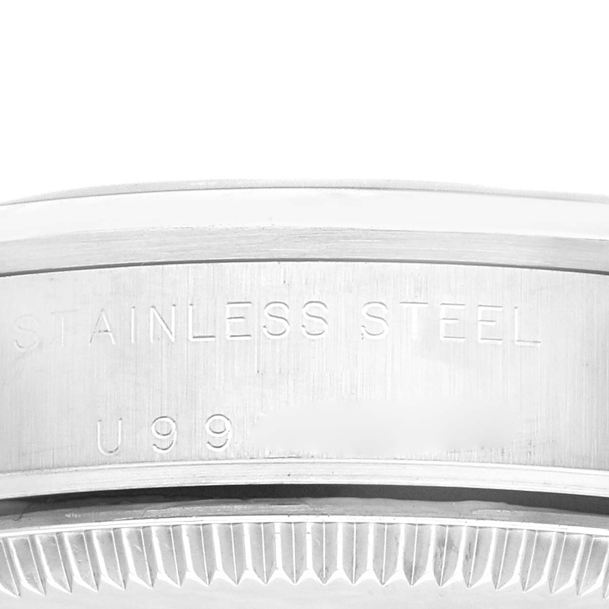 This close-up shows the side of a Rolex Mid-Size 77080 Women
s Stainless Steel Silver Dial 77080 Women
s Stainless Steel Silver Dial watch case, highlighting the "STAINLESS STEEL" engraving.