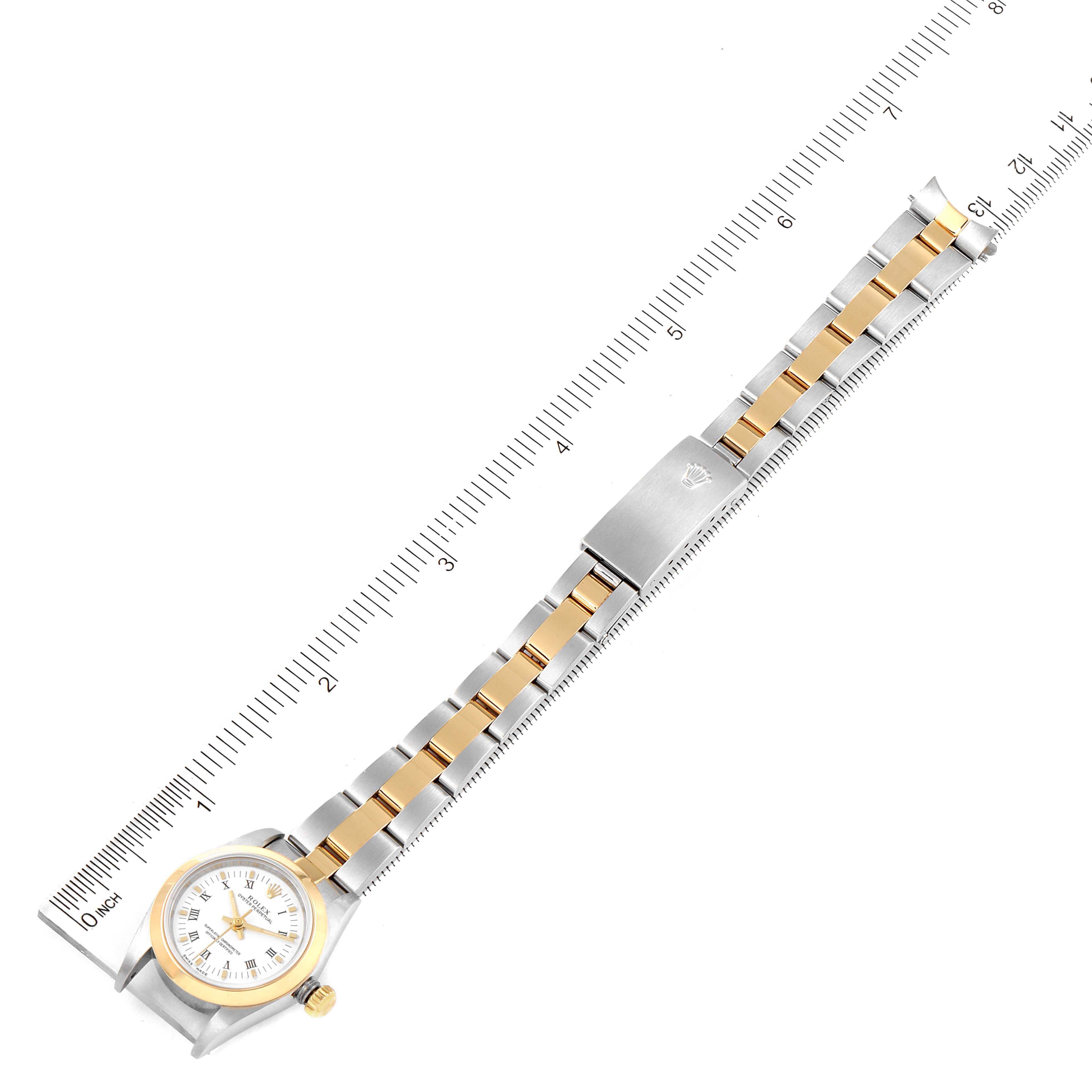 This image shows a Rolex Oyster Perpetual 76183 Women's Steel and Gold (two tone) White Dial 76183 Women's Steel and Gold (two tone) White Dial watch laid flat with its bracelet and clasp fully visible alongside a measurement ruler.