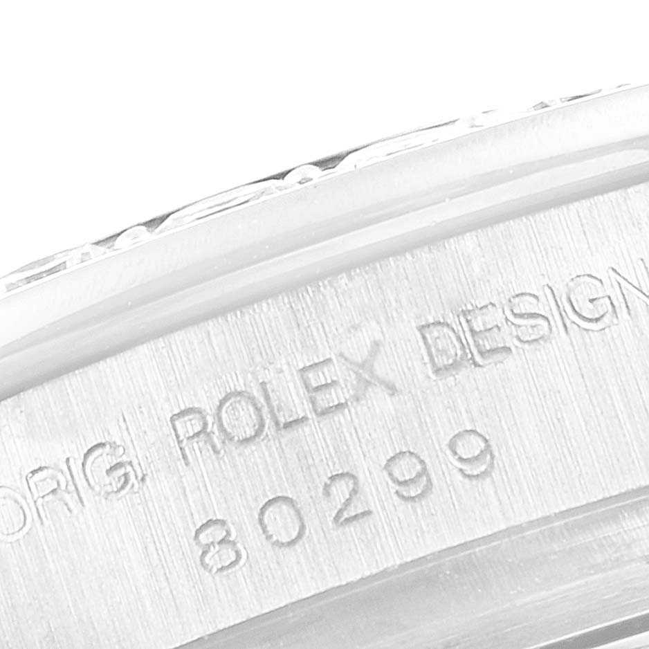 The image shows a close-up of the serial number and "Rolex Design" engraving on the side of a Rolex Pearlmaster 80299 Women's White Gold Mother of Pearl Dial 80299 Women's White Gold Mother of Pearl Dial watch case.