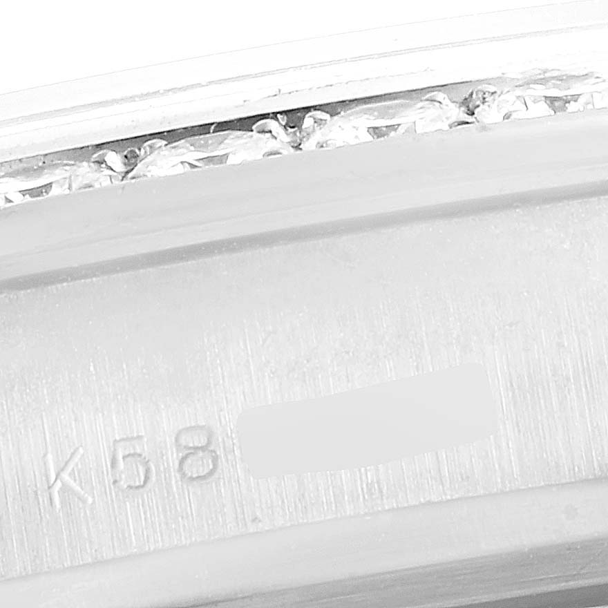 This close-up image shows the edge of a diamond-embedded bezel and partial serial number of the Rolex Pearlmaster 80299 Women's White Gold Mother of Pearl Dial 80299 Women's White Gold Mother of Pearl Dial watch.