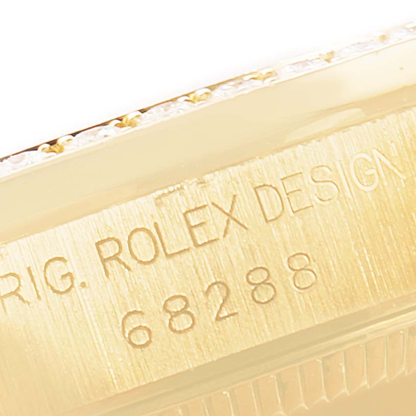 This image shows a close-up of the engraved serial number and design engraving on the bezel of the Rolex President 68288 Women
s Yellow Gold Champagne Dial 68288 Women
s Yellow Gold Champagne Dial model.