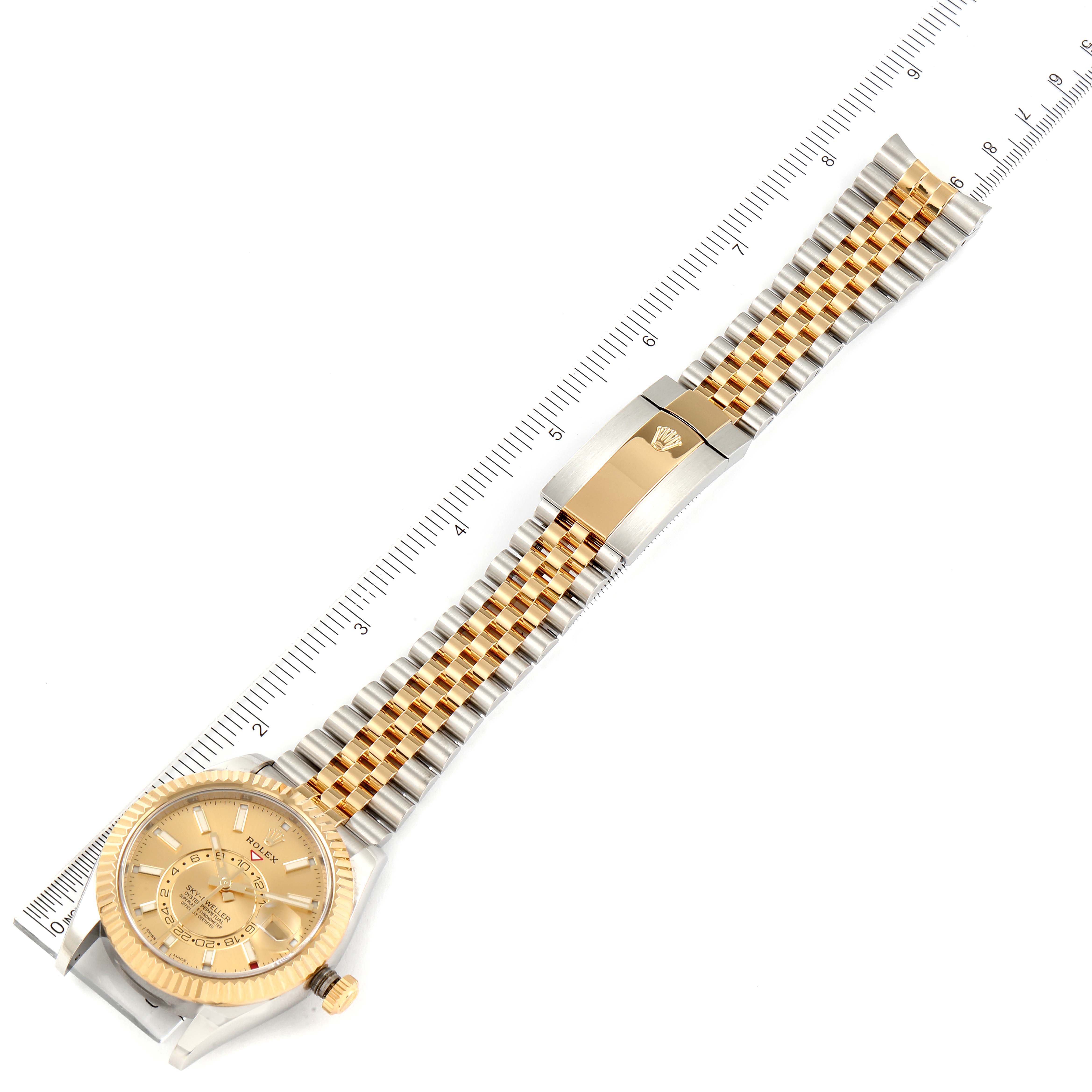 The image shows a full view of the Rolex Sky-Dweller 326933 Men's Steel and Gold (two tone) Champagne Dial 326933 Men's Steel and Gold (two tone) Champagne Dial watch laid flat, highlighting the gold-colored dial, bezel, and two-tone bracelet.