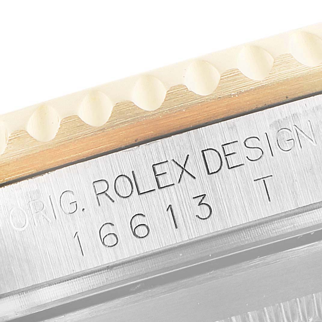 The close-up image shows the side of the bezel and engraved serial number on a Rolex Submariner 16613 Men's Steel and Gold (two tone) Champagne Dial 16613 Men's Steel and Gold (two tone) Champagne Dial model.