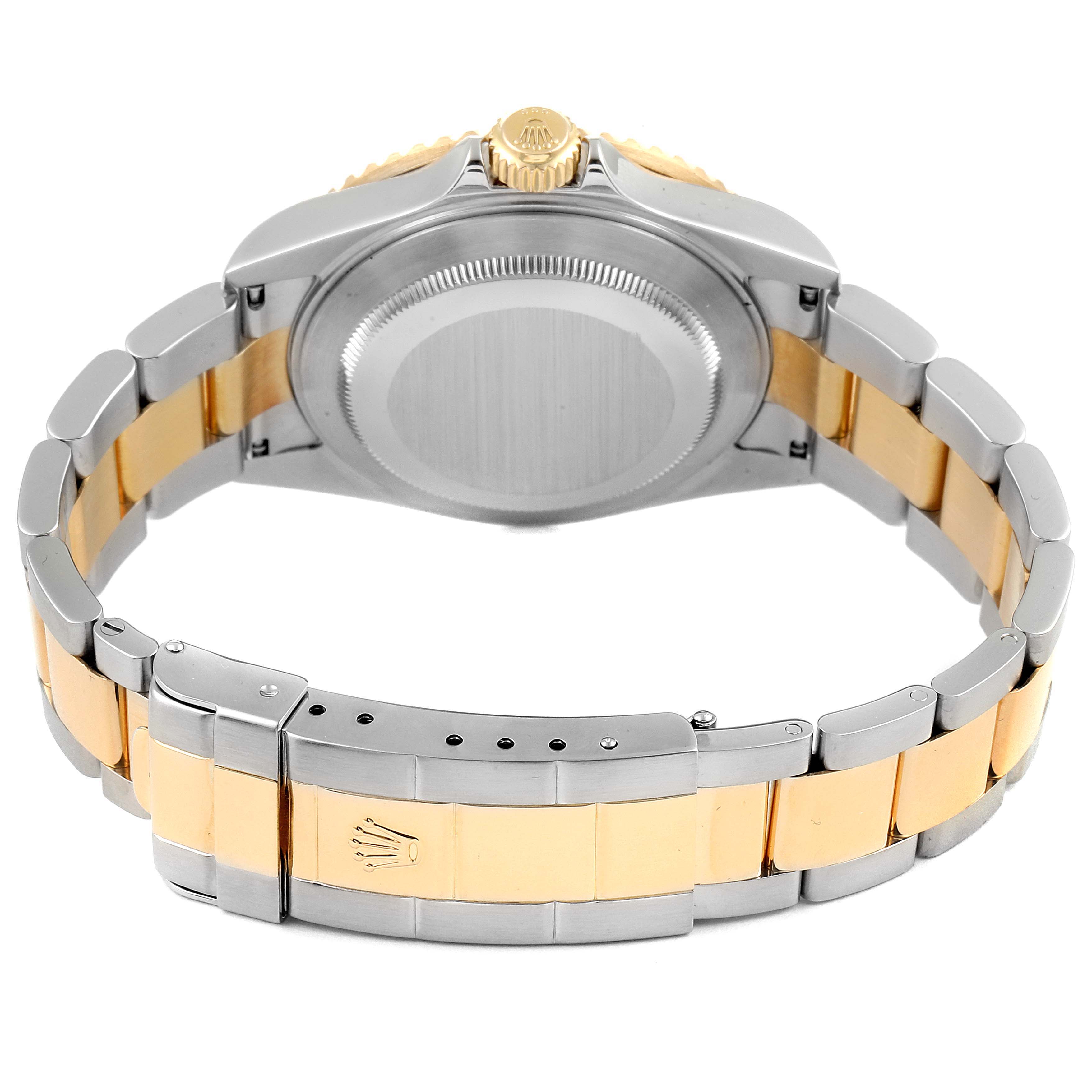 The image shows the back of a Rolex Submariner 16613 Men's Steel and Gold (two tone) Champagne Dial 16613 Men's Steel and Gold (two tone) Champagne Dial watch, highlighting its gold and silver bracelet and clasp.