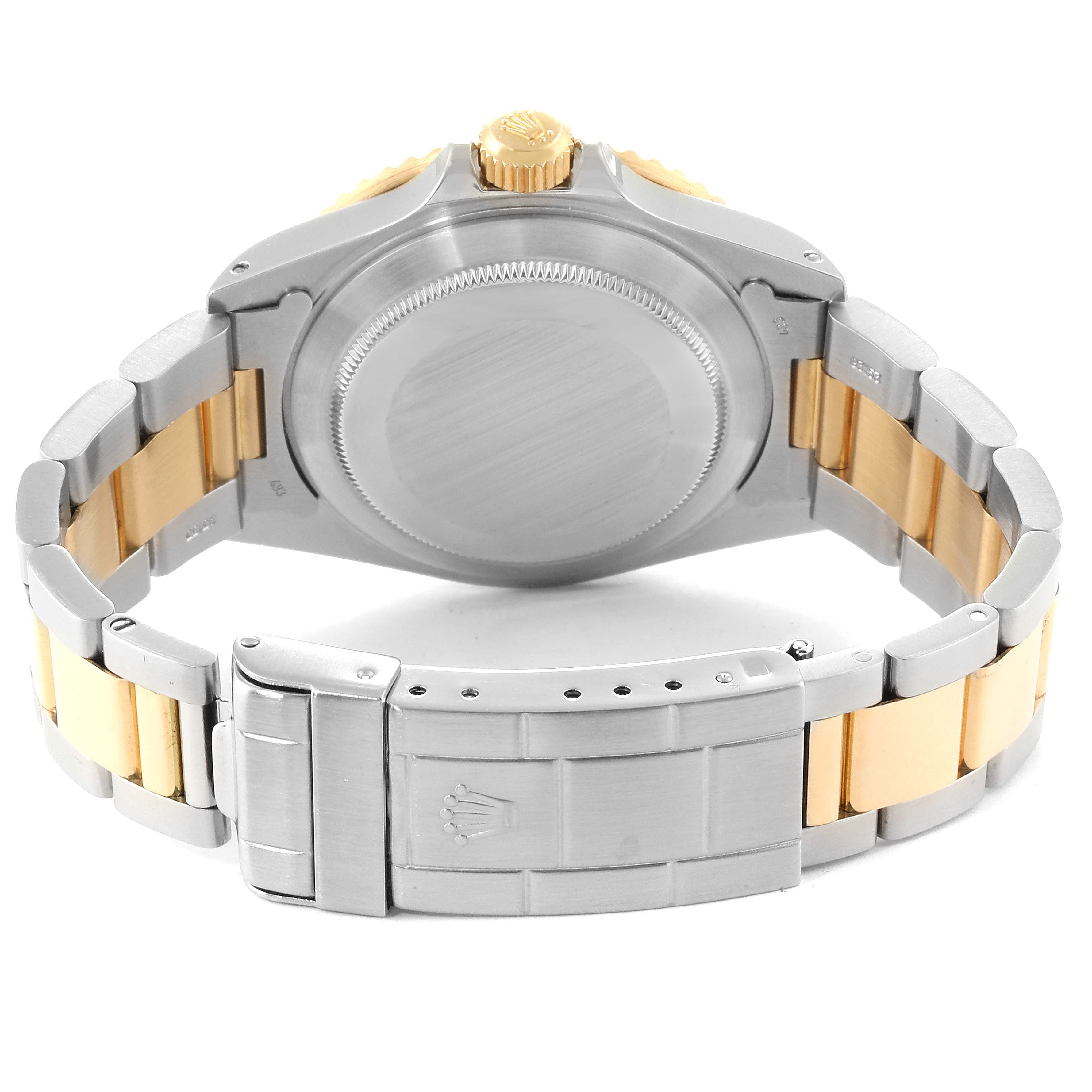 The image shows the back view of a Rolex Submariner 16803 Men
s Stainless Steel Grey Dial 16803 Men
s Stainless Steel Grey Dial, highlighting the caseback and part of the bracelet with a clasp.