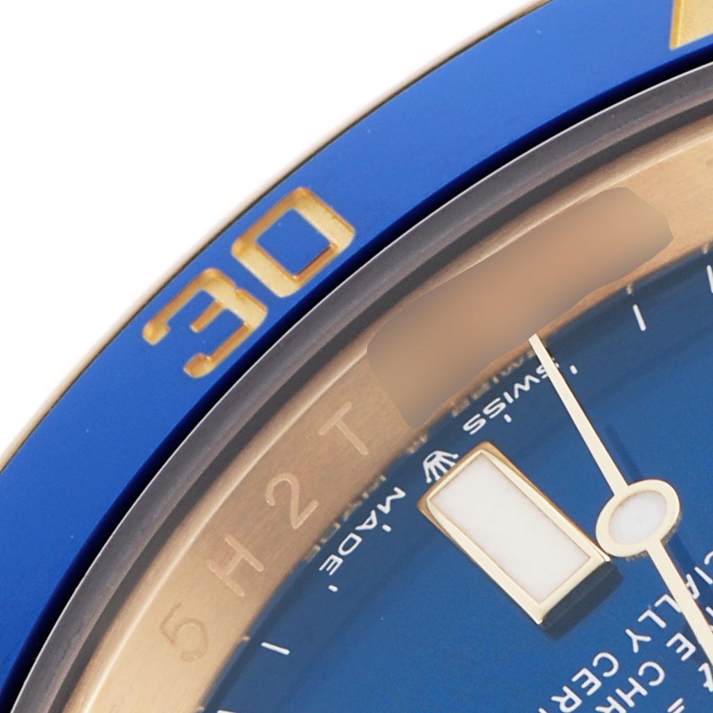 The image shows a close-up of the bezel and dial of a Rolex Submariner 126618LB Men's Yellow Gold Blue Dial 126618LB Men's Yellow Gold Blue Dial, highlighting the blue and gold elements near the 30-minute mark.