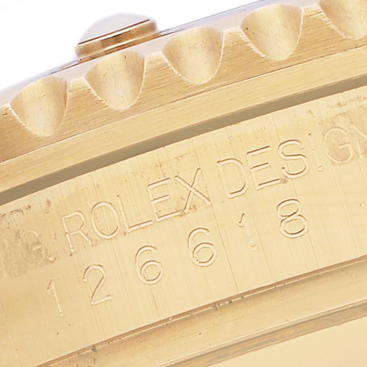 The image shows a close-up of the engraved side of a Rolex Submariner 126618LB Men's Yellow Gold Blue Dial 126618LB Men's Yellow Gold Blue Dial, highlighting the bezel edge and model number on the case.