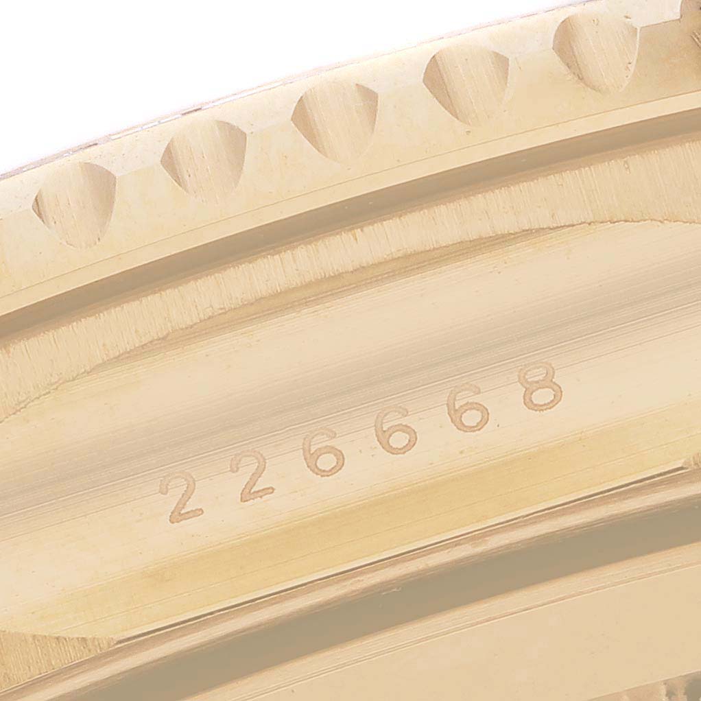 The image shows a close-up of the bezel and serial number area of a Rolex Yacht-Master M226668TBR-0001 Men's Yellow Gold Champagne Dial watch.