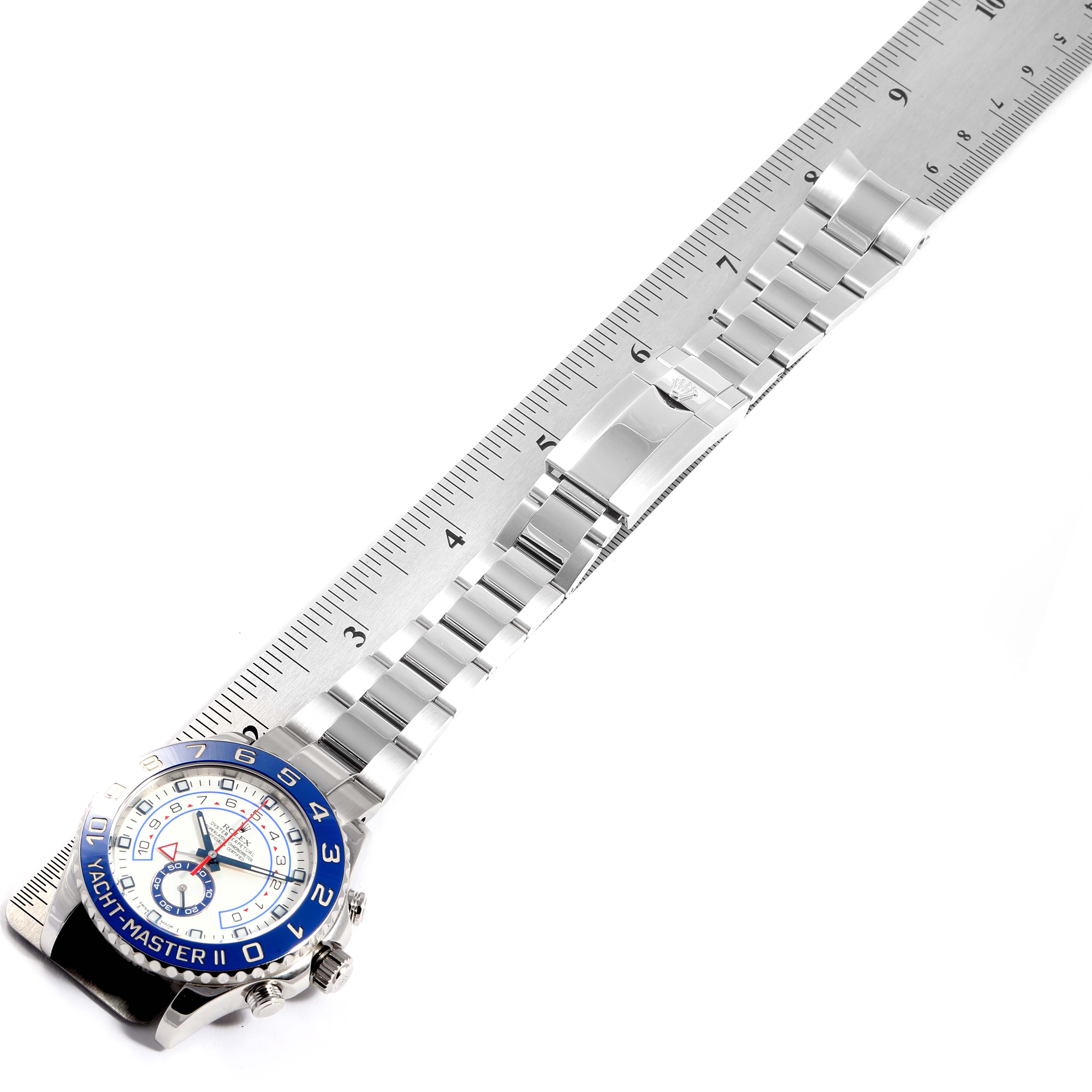 The Rolex Yacht-Master 116680 Men
s Stainless Steel White Dial 116680 Men
s Stainless Steel White Dial watch is shown laid flat with its stainless steel bracelet extended and a ruler measuring its length.