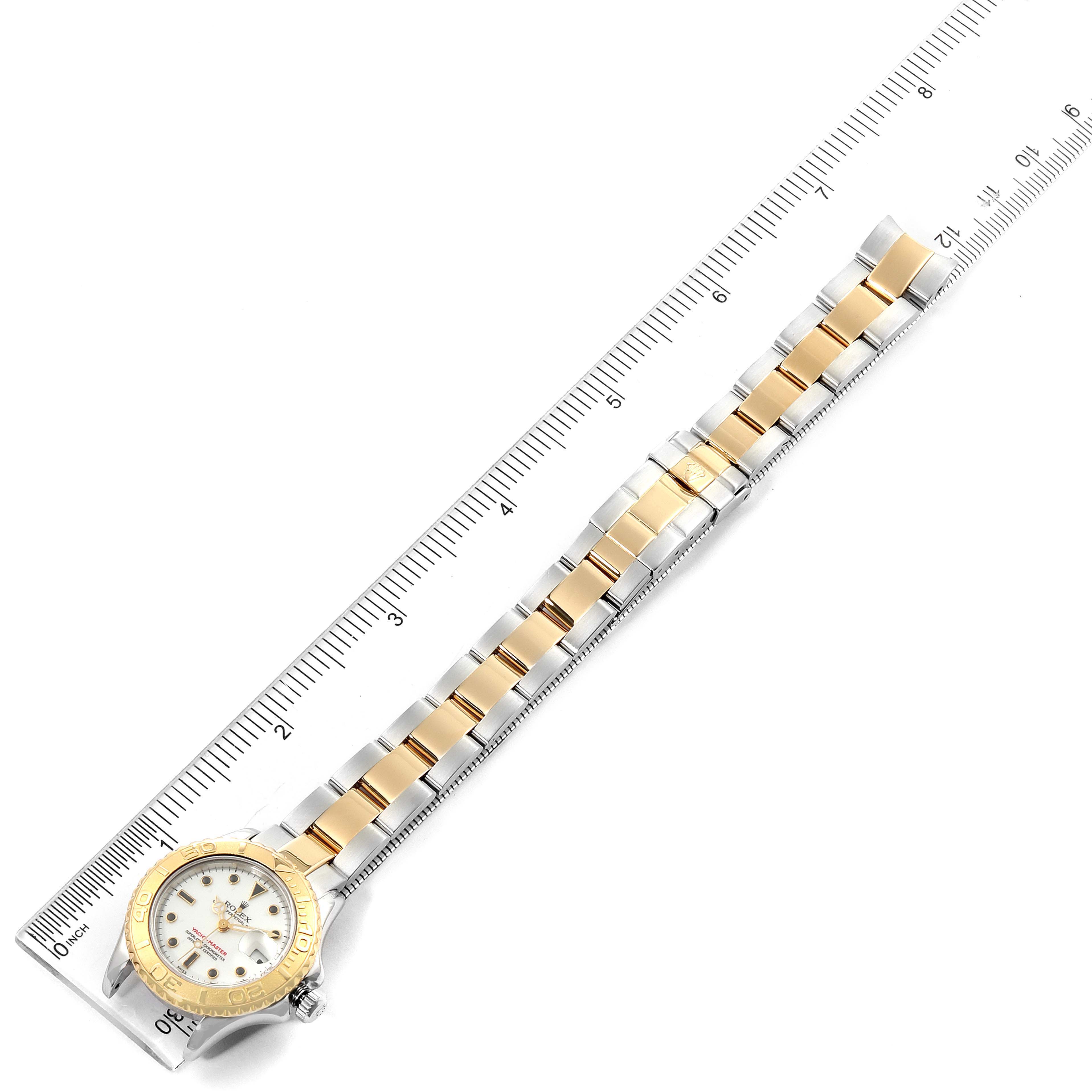 The Rolex Yacht-Master 169623 Women's Steel and Gold (two tone) White Dial 169623 Women's Steel and Gold (two tone) White Dial watch is displayed flat with a ruler, showing its full face and bracelet length.