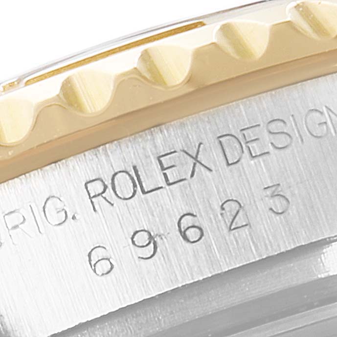This close-up shows the edge of the bezel and part of the case of a Rolex Yacht-Master 69623 Women's Steel and Gold (two tone) Grey Dial 69623 Women's Steel and Gold (two tone) Grey Dial watch with model details inscribed.