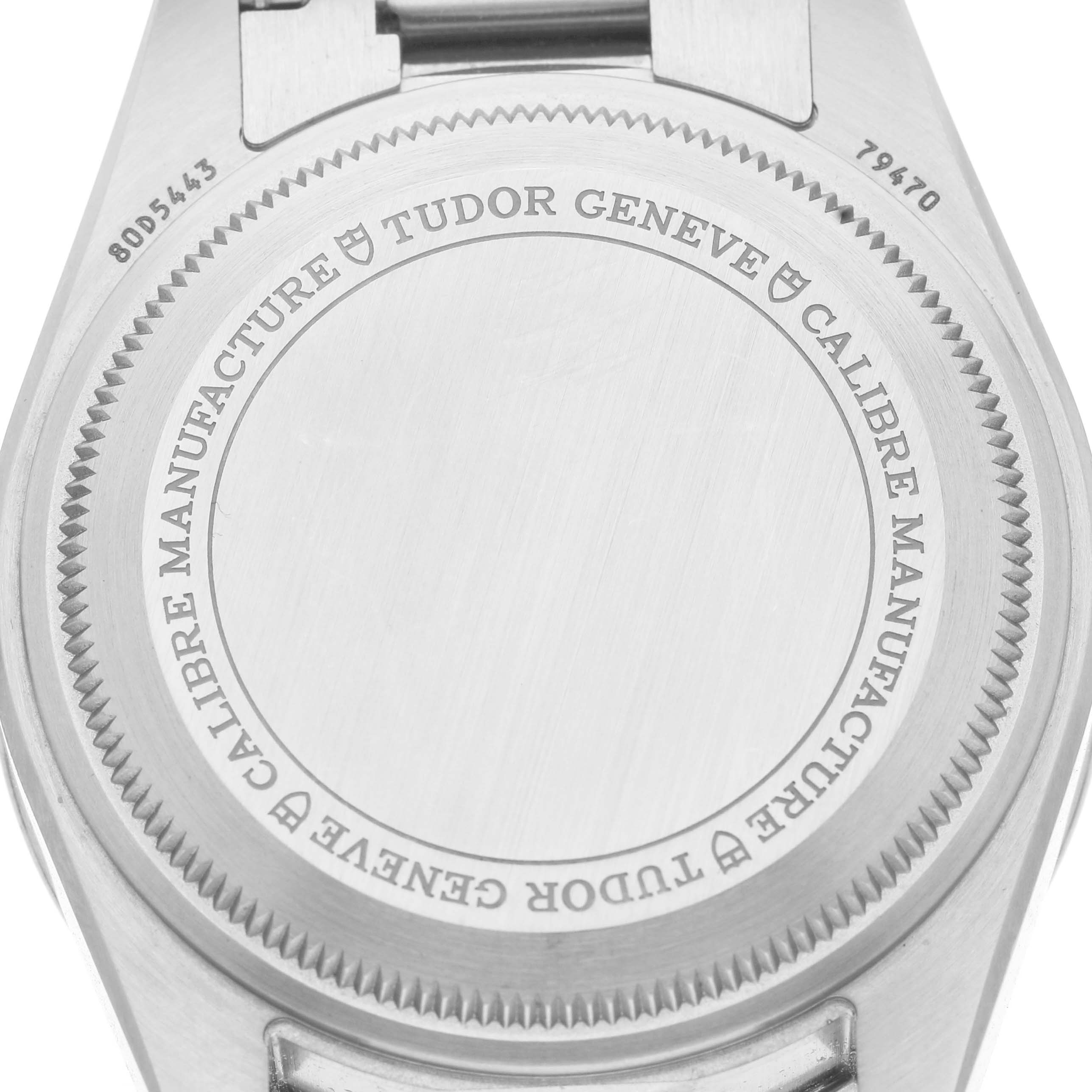 The image shows the back case of a Tudor Heritage Black Bay M79470-0001 Men's Stainless Steel Black Dial watch with engraved details.