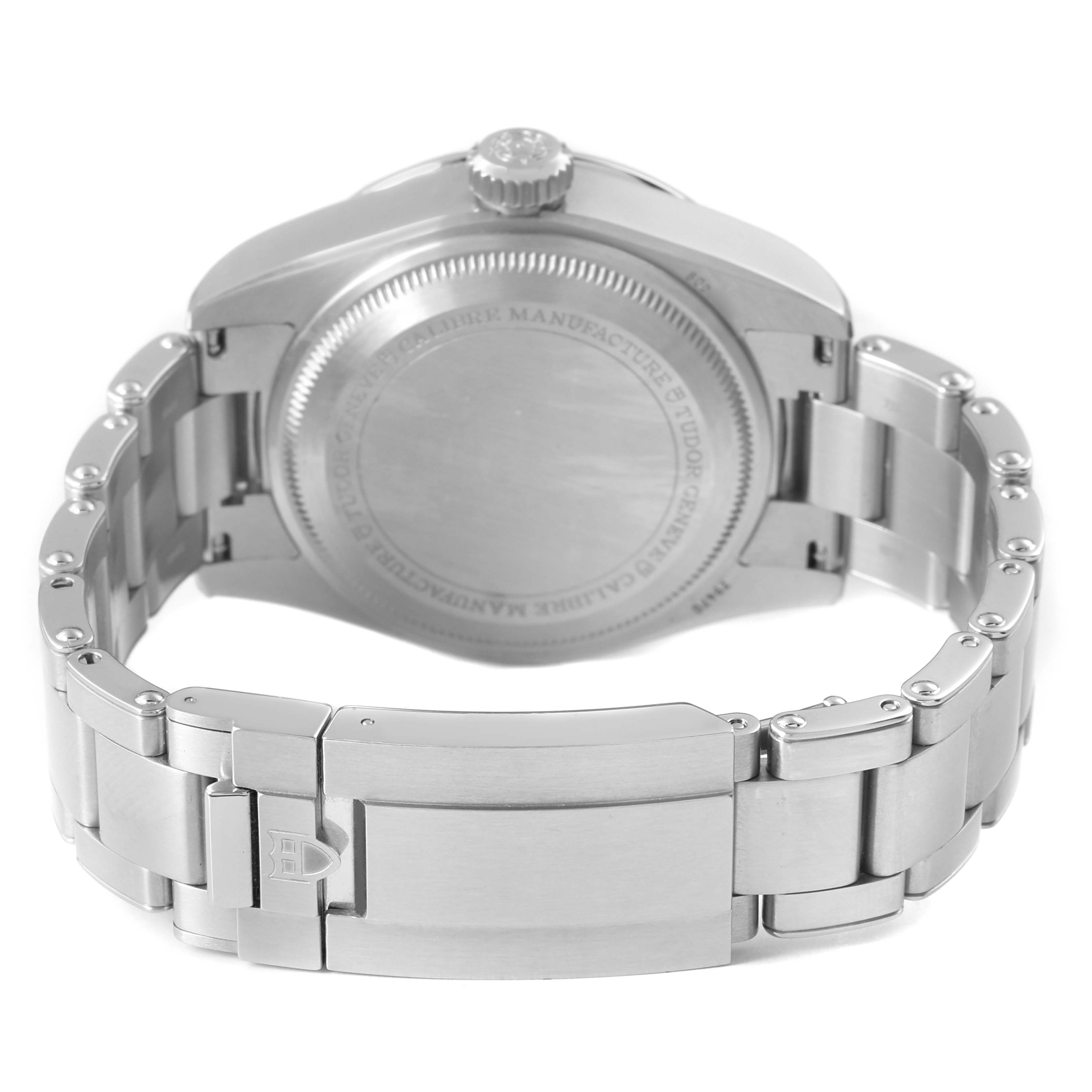 The image shows the back view of a Tudor Heritage Black Bay M79470-0001 Men's Stainless Steel Black Dial watch, highlighting the case back and metal bracelet with a clasp.