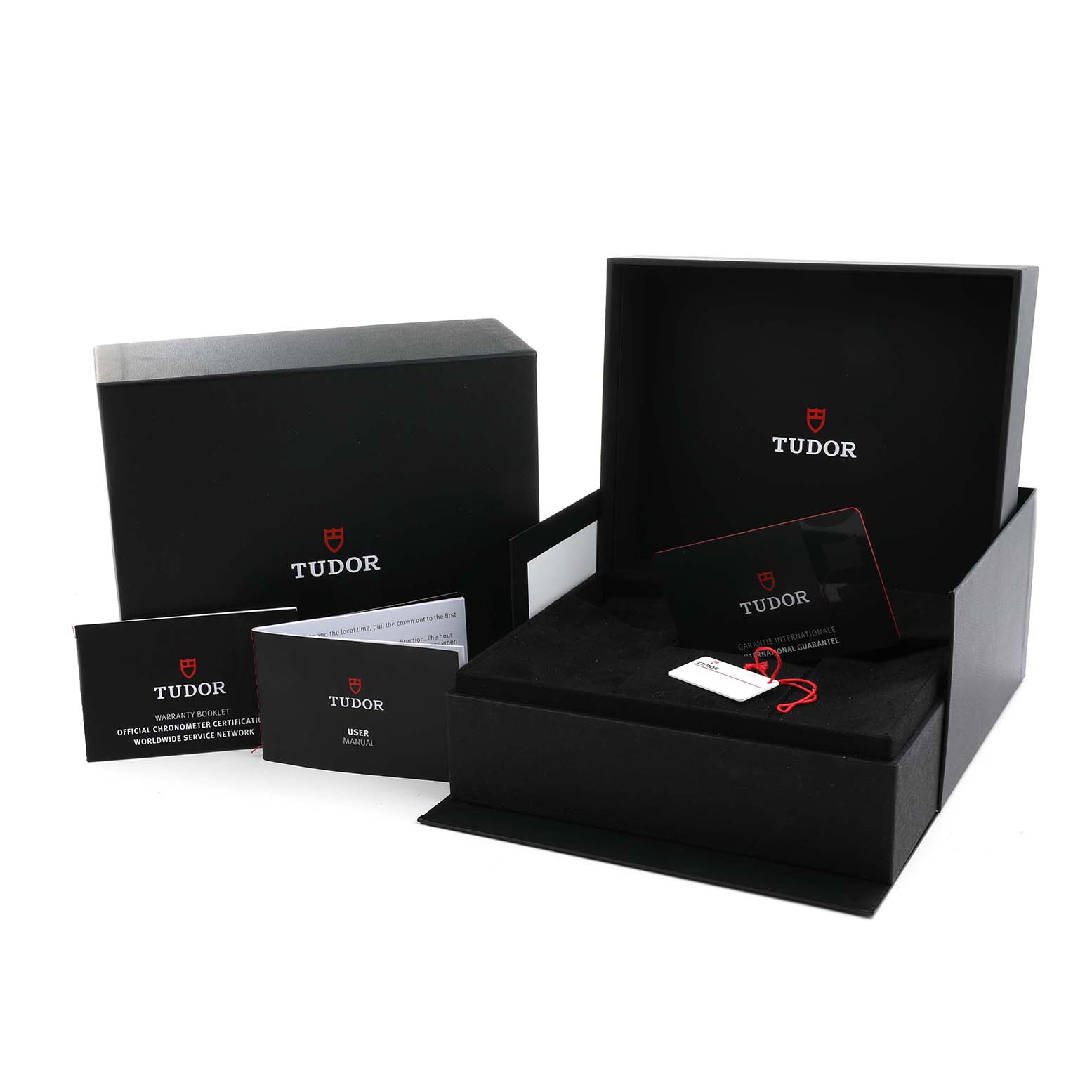 The image shows the Tudor Heritage Black Bay M79470-0001 Men's Stainless Steel Black Dial packaging, including the box, warranty cards, and user manuals.