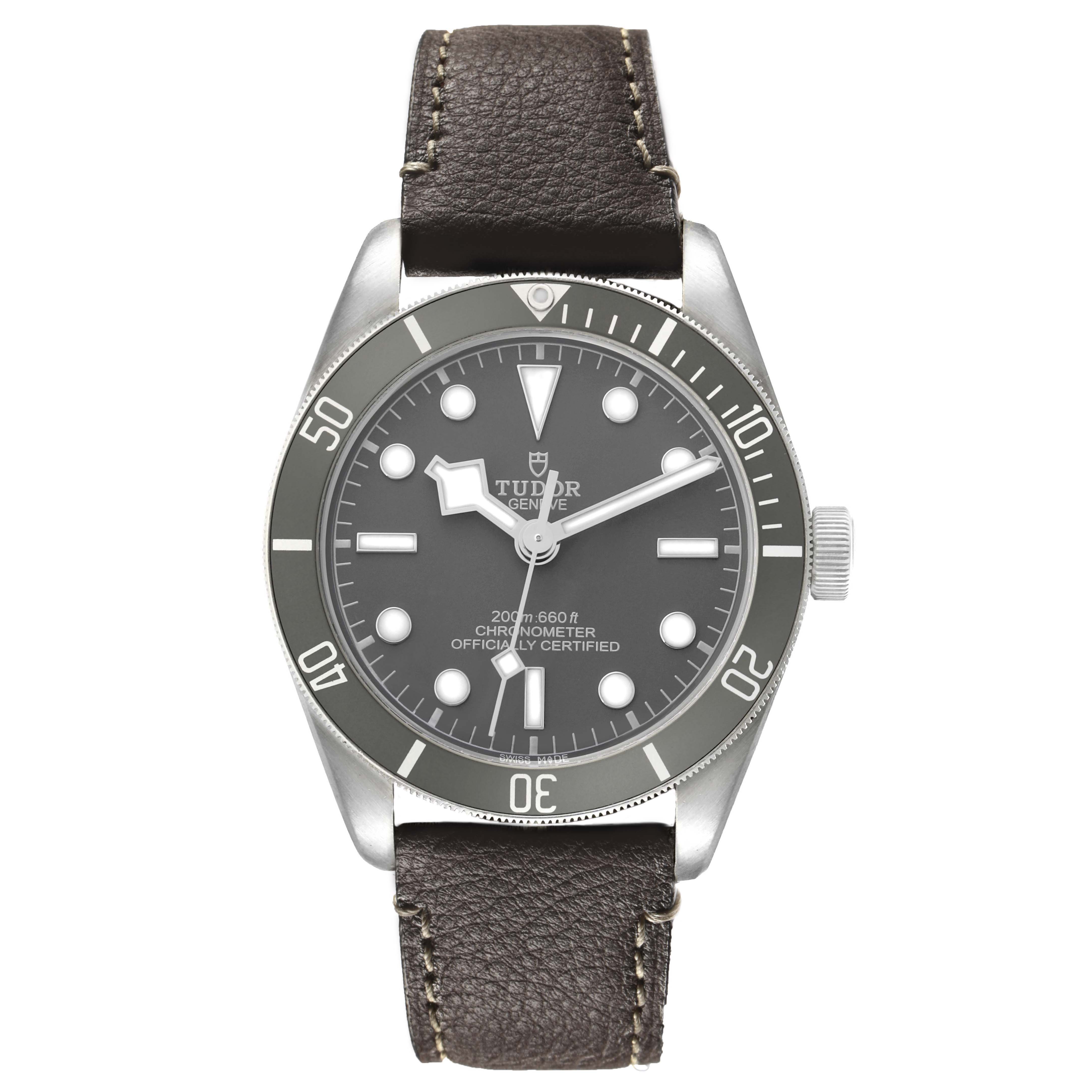 The Tudor Heritage Black Bay M79010SG-0001 Men's Stainless Steel Grey Dial model is shown from a top-down angle, highlighting the watch face, bezel, and leather strap.