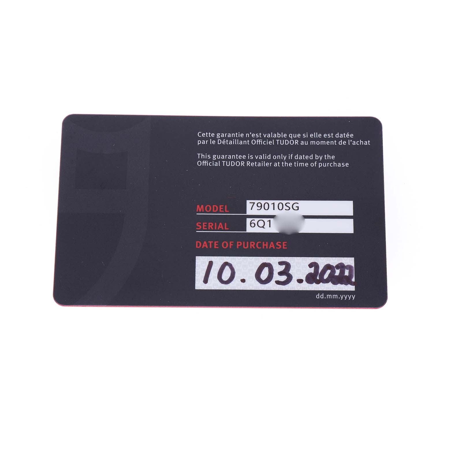 The image shows a close-up of the warranty card for the Tudor Heritage Black Bay M79010SG-0001 Men's Stainless Steel Grey Dial watch, displaying model, serial number, and purchase date.