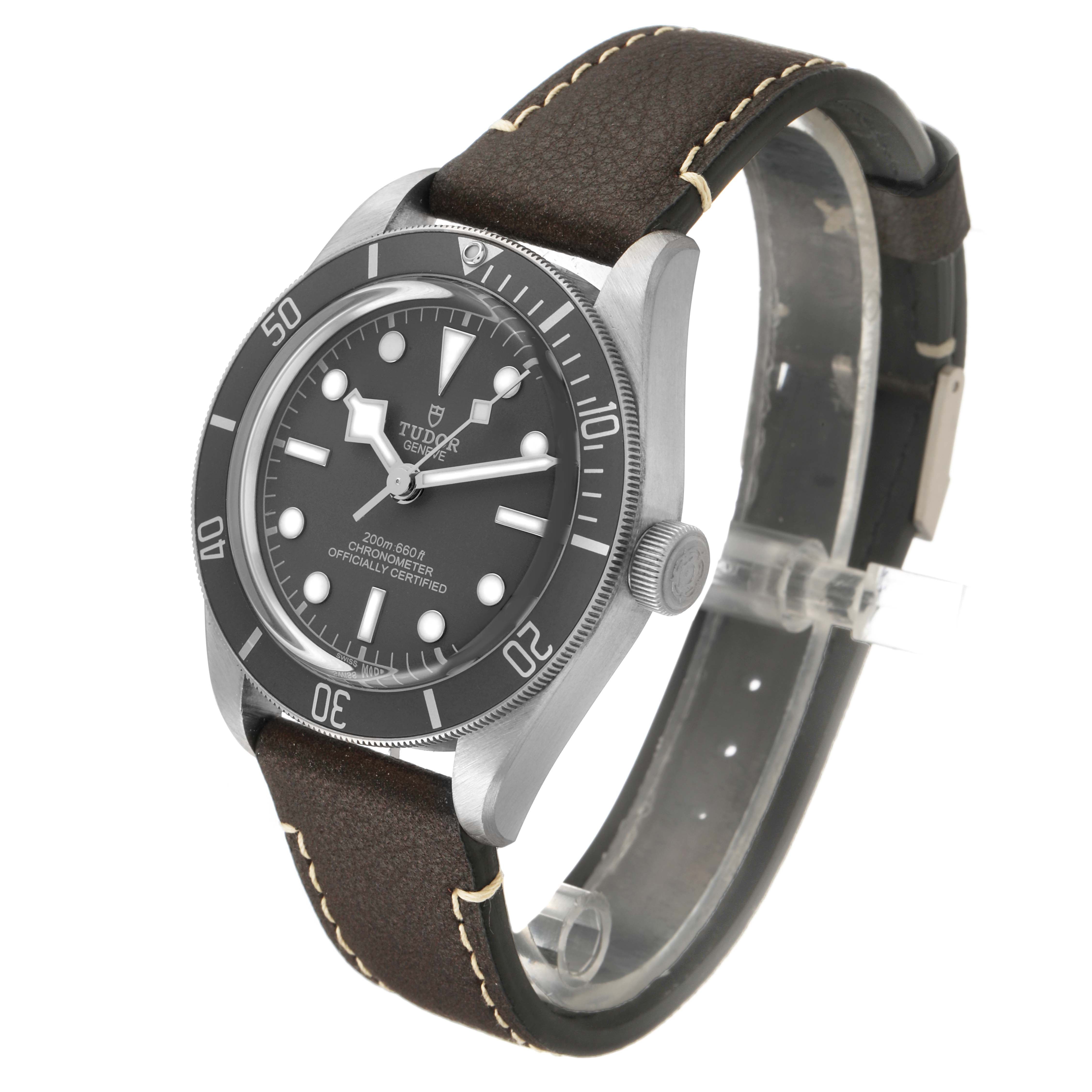 The Tudor Heritage Black Bay M79010SG-0001 Men's Stainless Steel Grey Dial watch is shown at a slight angle, highlighting the face, bezel, crown, and brown leather strap.