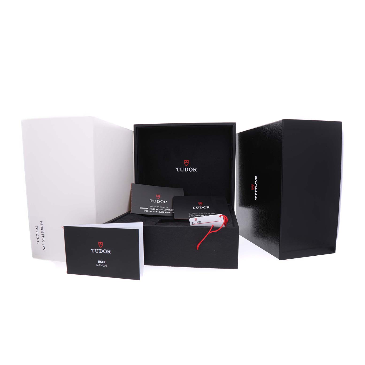 The image shows open packaging for the Tudor Heritage Black Bay M79010SG-0001 Men's Stainless Steel Grey Dial, including boxes, manuals, and accessories from a frontal angle.