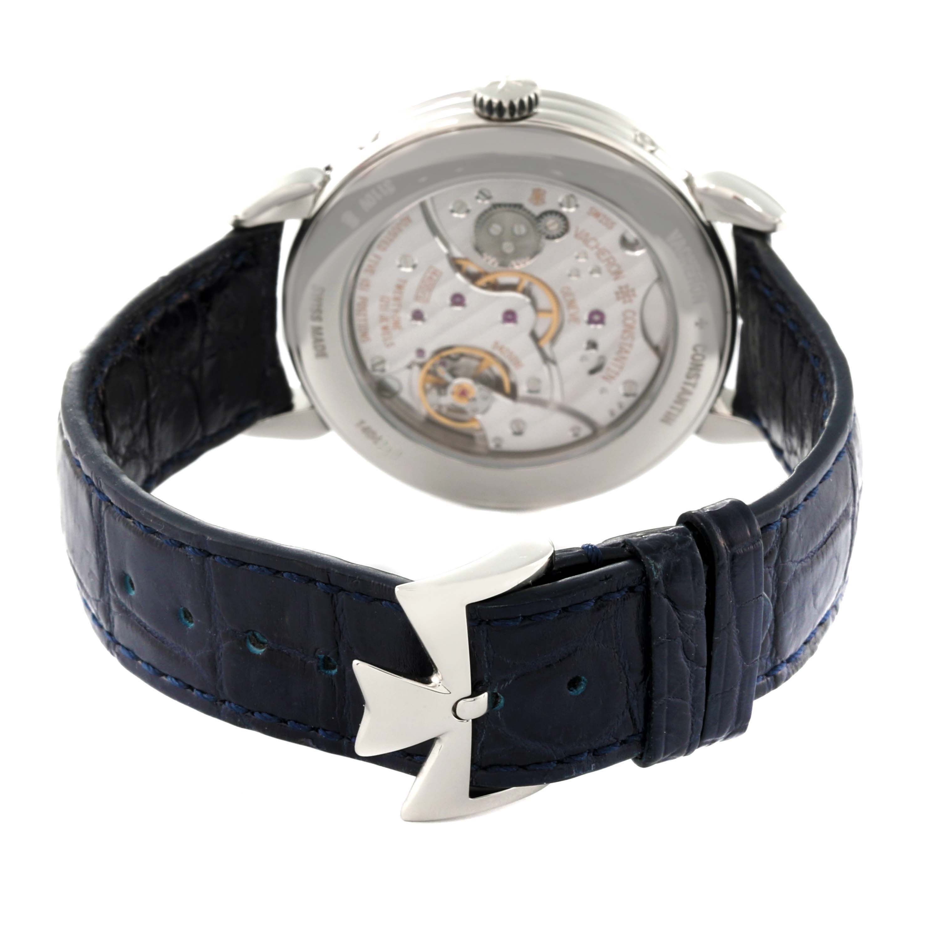 The image shows the back view of the Vacheron Constantin Historiques 3110V/000A-B426 Men's Stainless Steel Silver Dial 3110V/000A-B426 Men's Stainless Steel Silver Dial watch, highlighting its movement and black leather strap with a Maltese cross buckle.