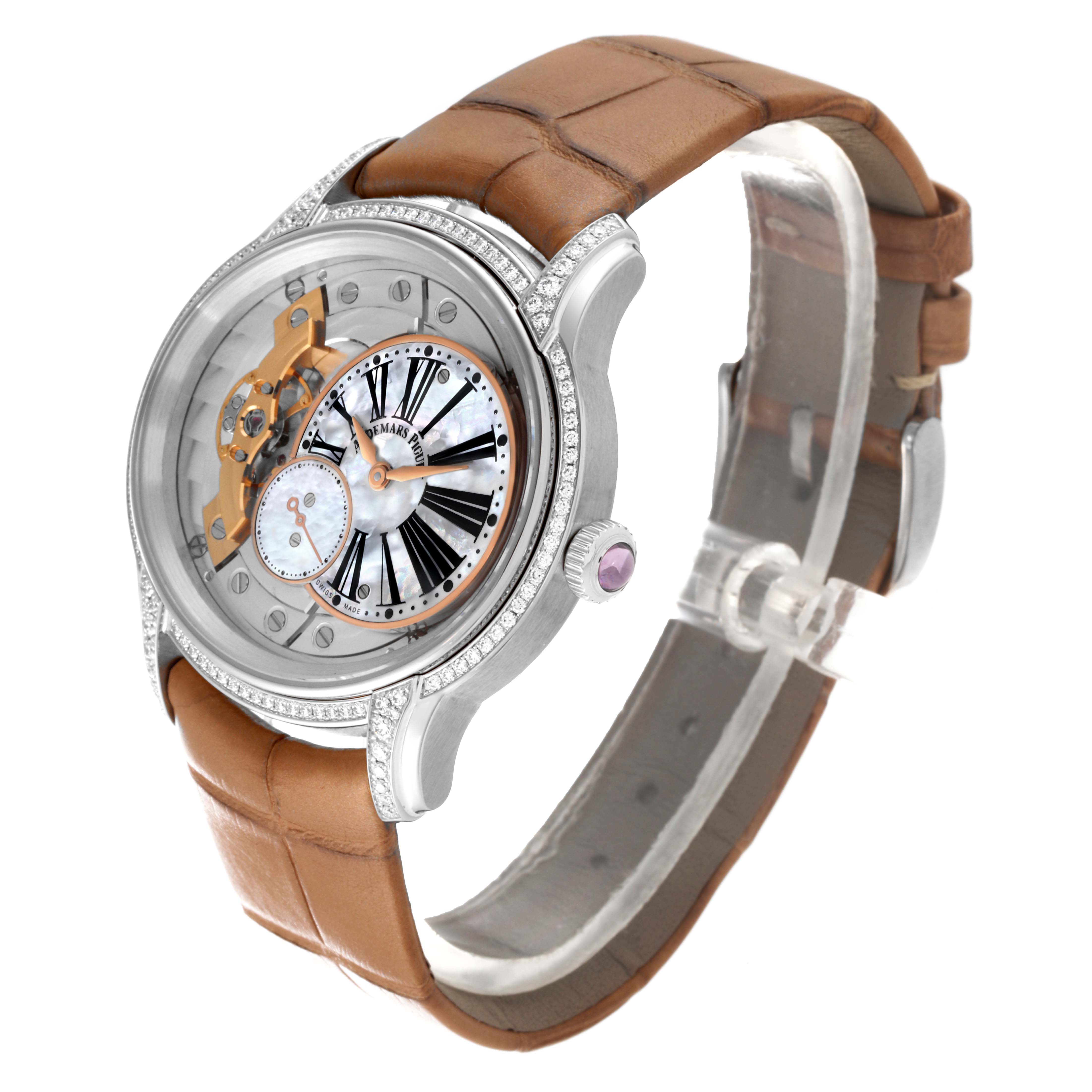 The Audemars Piguet Millenary 77247BC.ZZ.A813CR.01 Women's White Gold Mother of Pearl Dial 77247BC.ZZ.A813CR.01 Women's White Gold Mother of Pearl Dial watch is shown at an angle highlighting its face, case, crown, and brown strap.