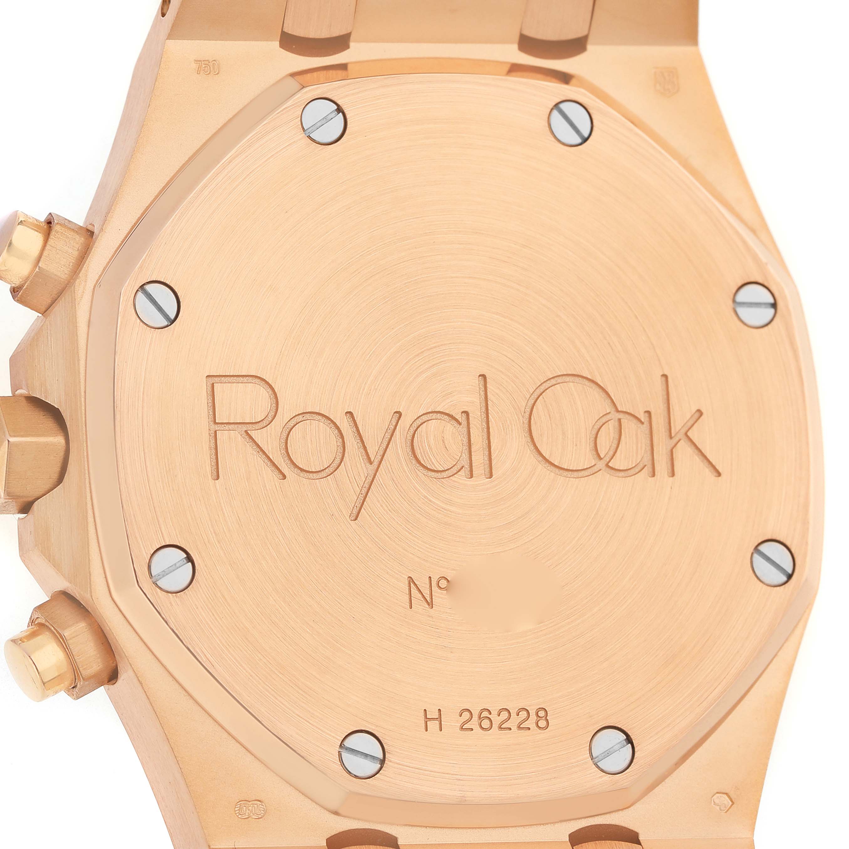The image shows the case back of an Audemars Piguet Royal Oak 26022OR.OO.D098CR.01 Men's Rose Gold Silver Dial watch, featuring engraved text and visible screws.