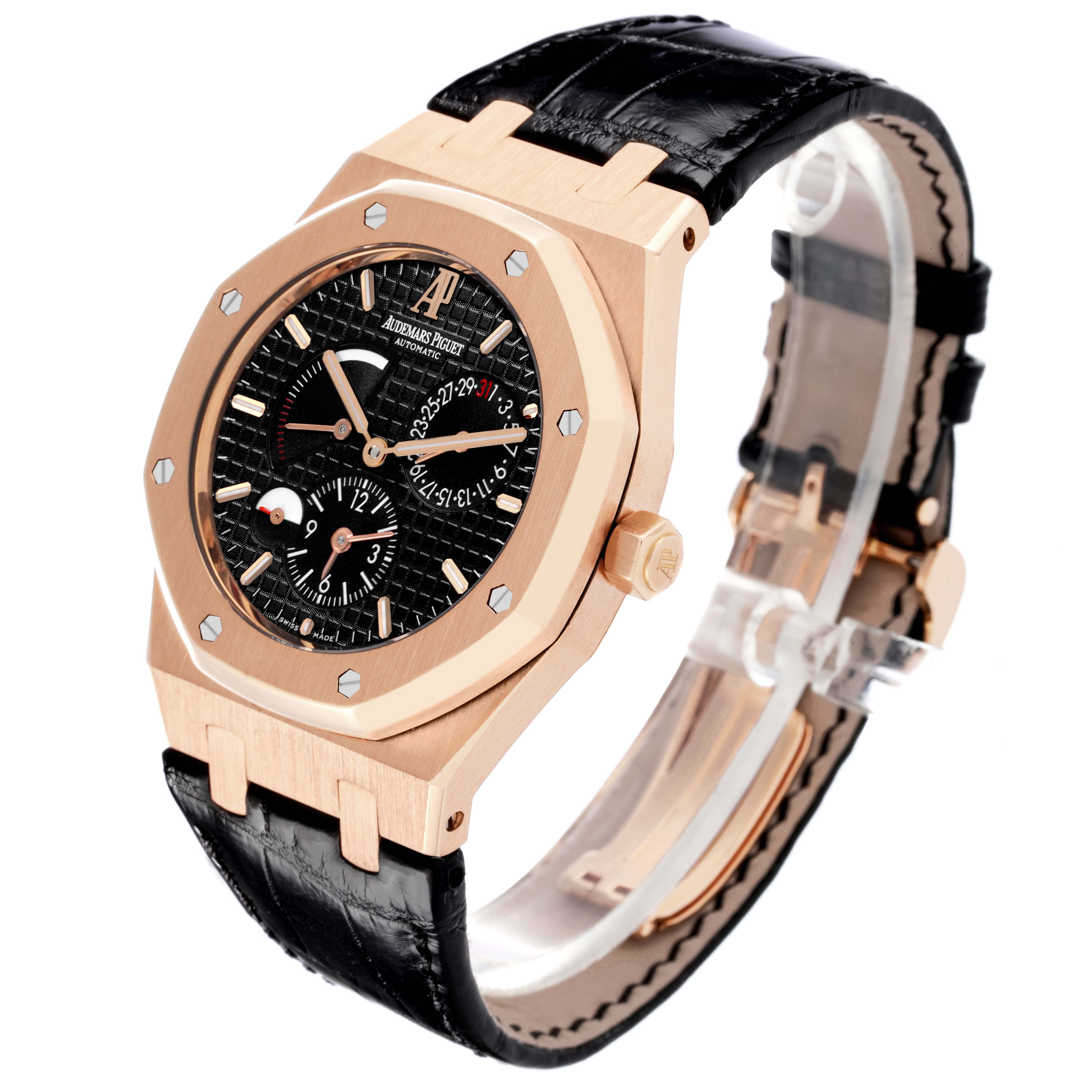 The Audemars Piguet Royal Oak 26120OR Men's Rose Gold Black Dial 26120OR Men's Rose Gold Black Dial is shown at an angled view, highlighting its rose gold face, black strap, and visible dial complications.