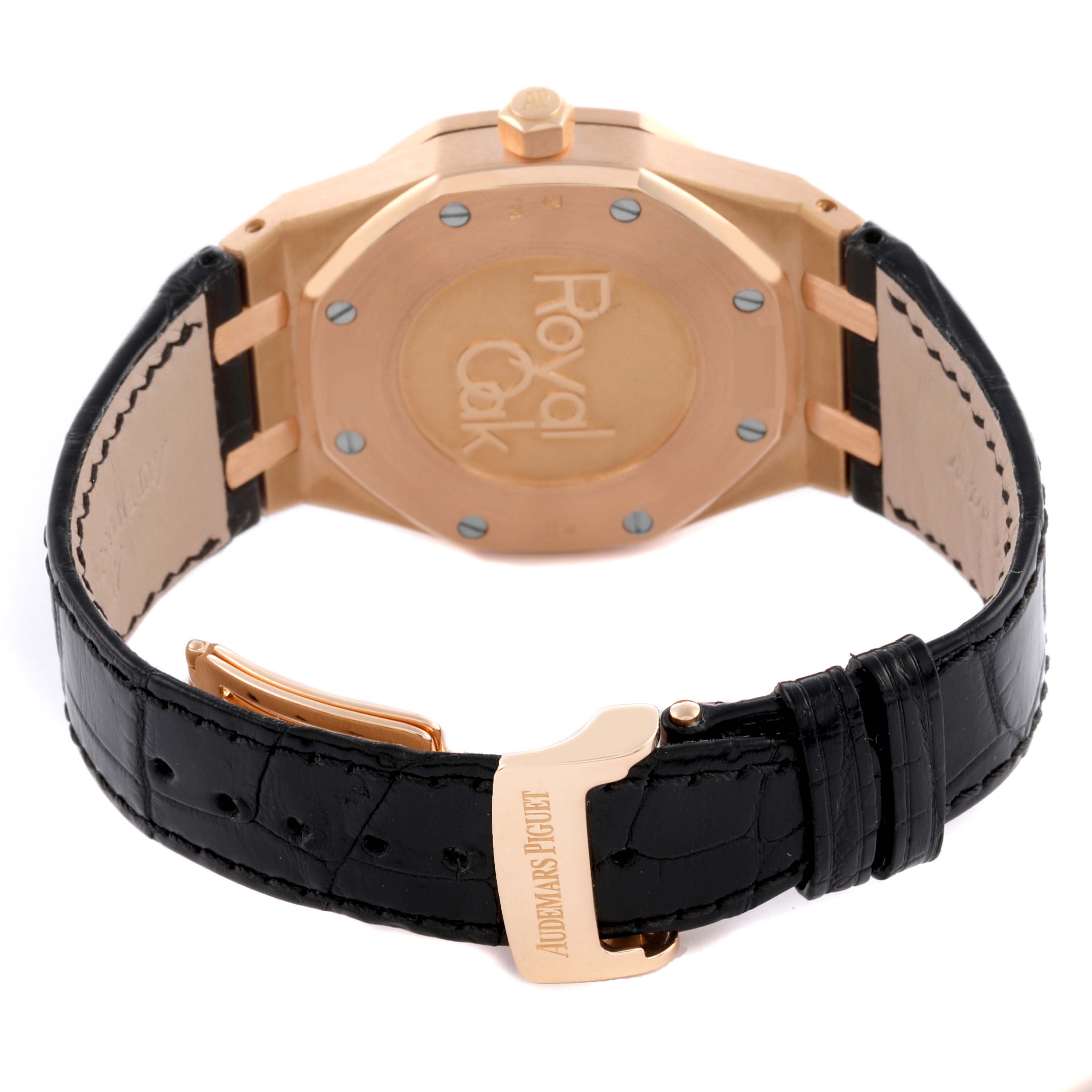 The image shows the back of an Audemars Piguet Royal Oak 26120OR Men's Rose Gold Black Dial 26120OR Men's Rose Gold Black Dial watch, featuring its clasp, strap, and embossed case back.