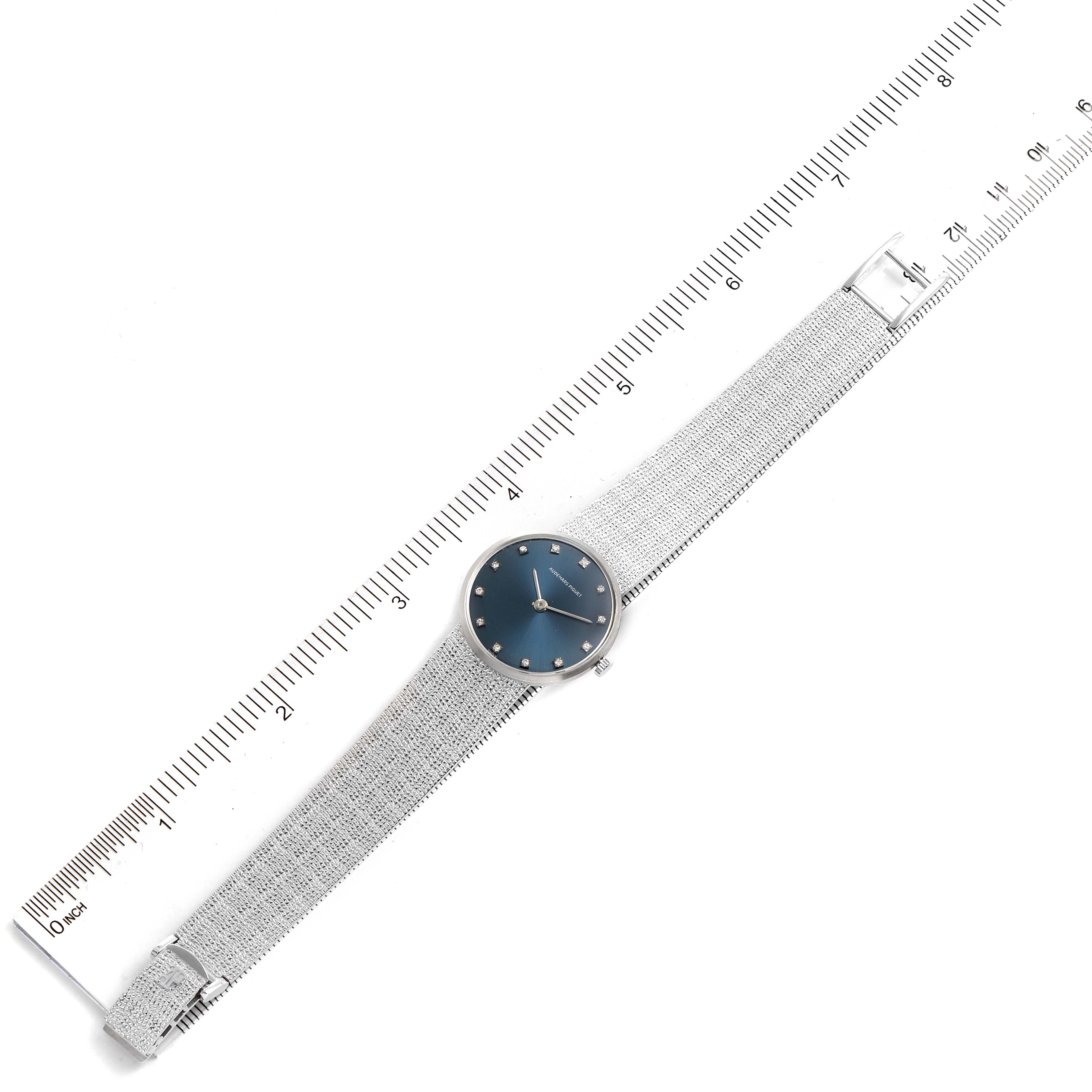 This image shows an overhead view of a Vintage Audemars Piguet watch with a blue dial placed beside a ruler.