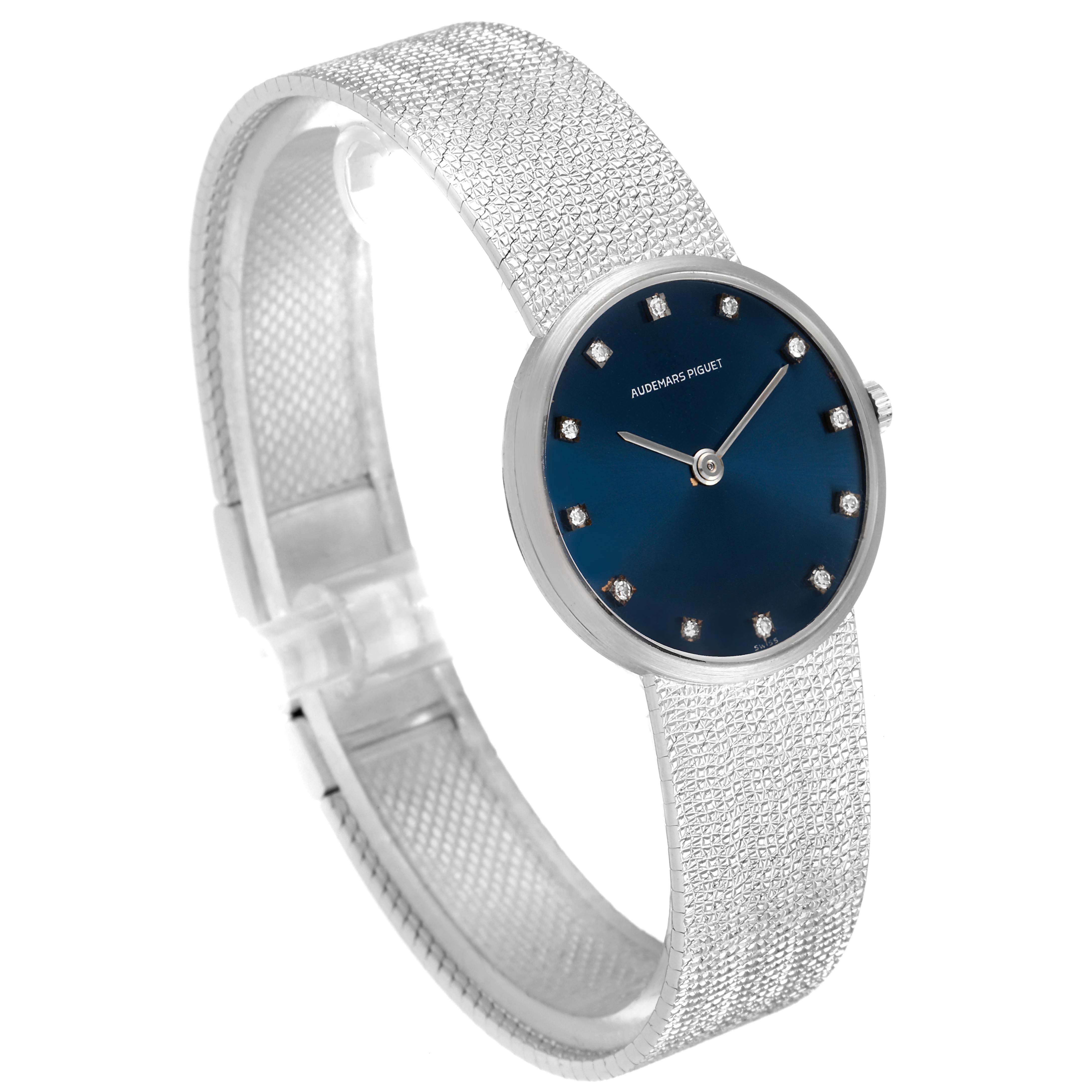 This image shows a side angle view of the Vintage Audemars Piguet watch, highlighting its blue dial and textured silver band.