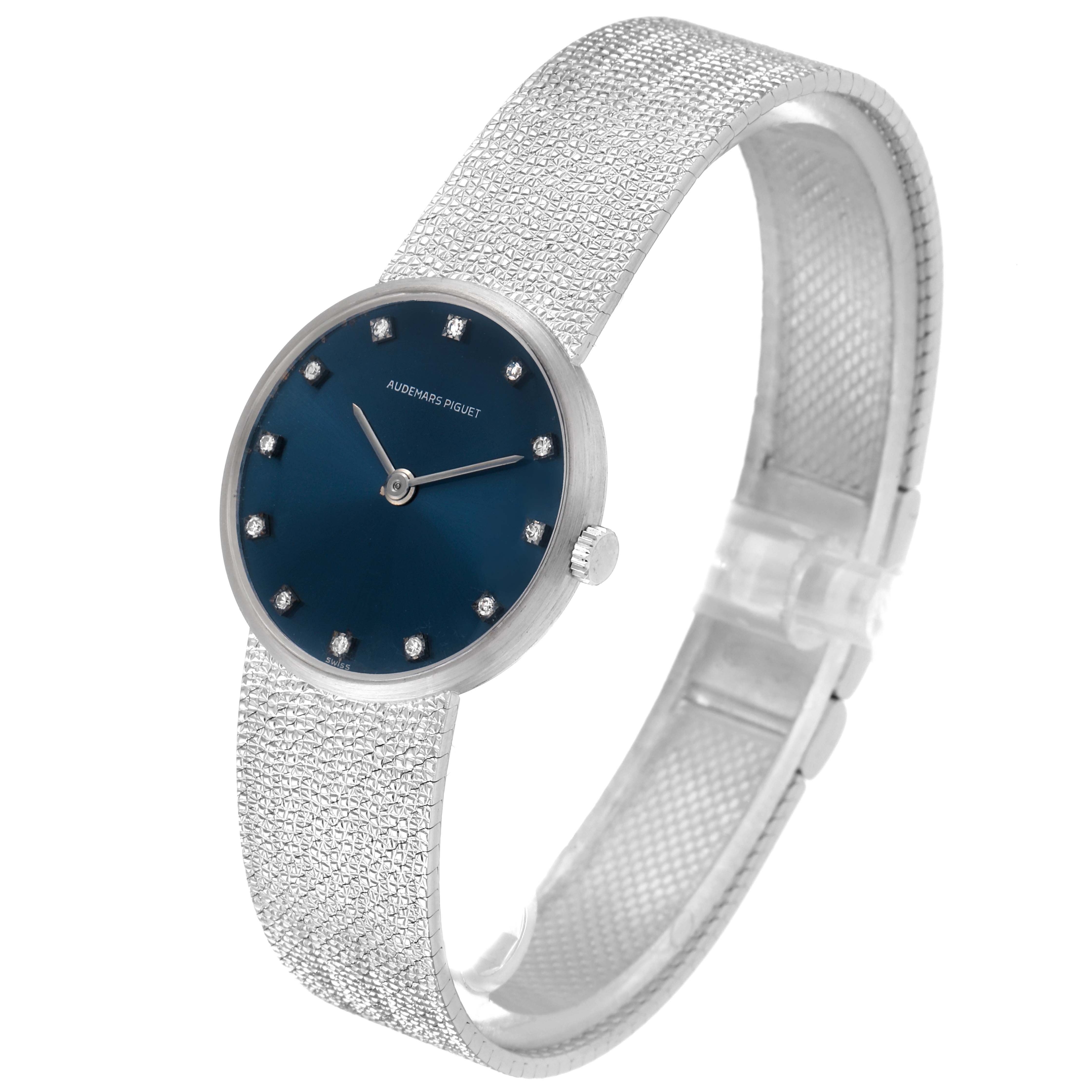 This image shows a side angle of a vintage Audemars Piguet watch, highlighting its blue dial, diamond markers, and textured bracelet.