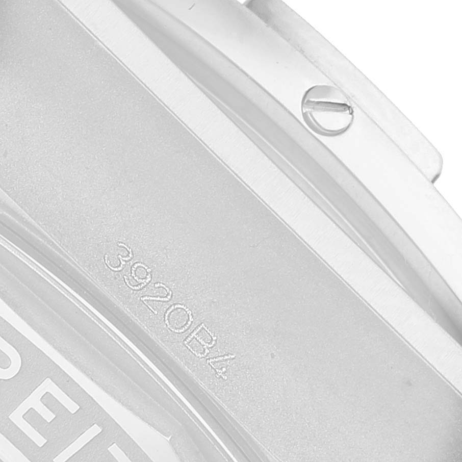 The image shows a close-up of the side of a Breitling Chronomat AB0134 Men's Stainless Steel Black Dial watch, focusing on the serial number and screw detail.