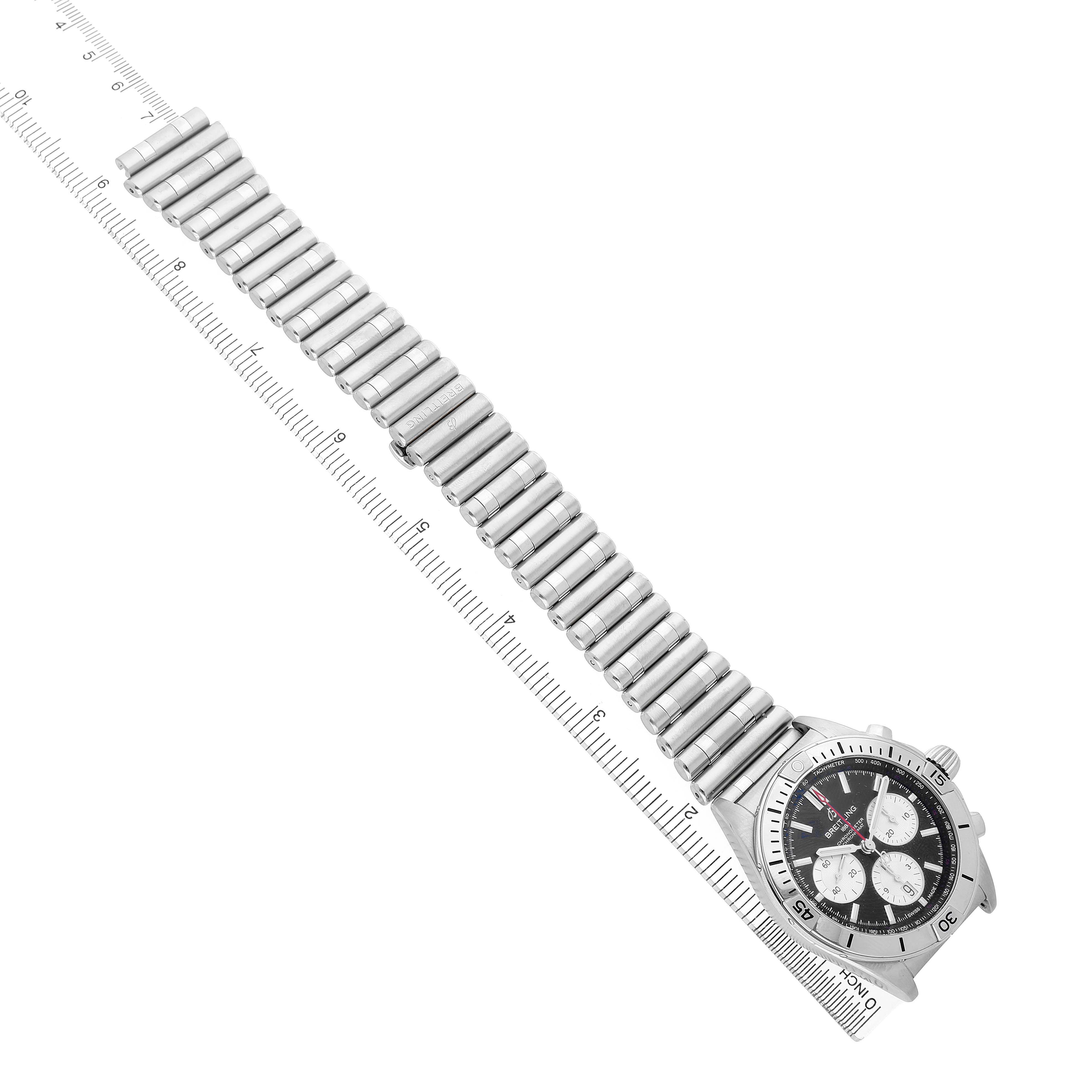 The Breitling Chronomat AB0134 Men's Stainless Steel Black Dial watch is shown from a top-down angle, displaying the full bracelet and face beside a ruler for scale.