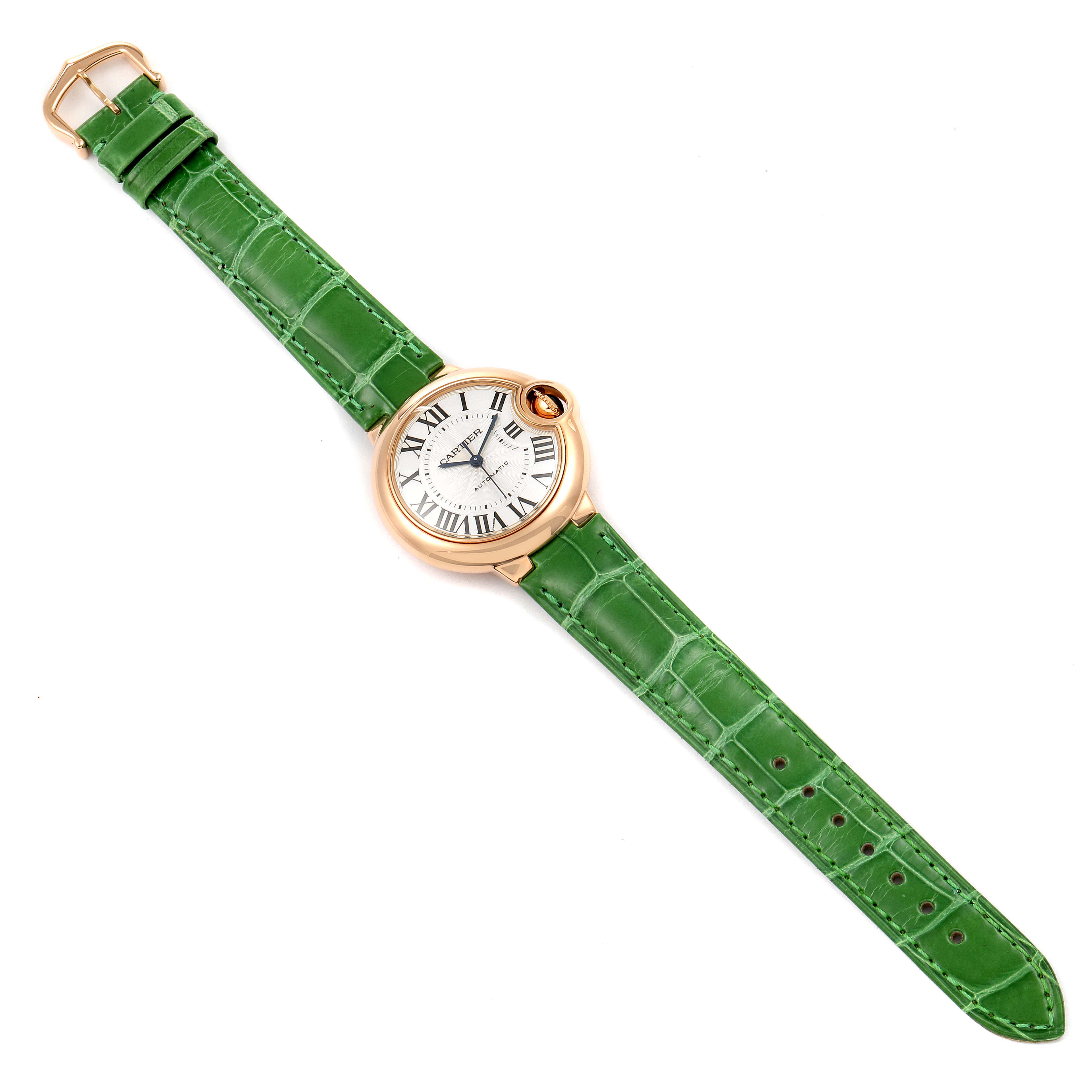 The image shows a top view of a Cartier Ballon Bleu W6920097 Women's Rose Gold Silver Dial W6920097 Women's Rose Gold Silver Dial watch with a green leather strap and gold case.