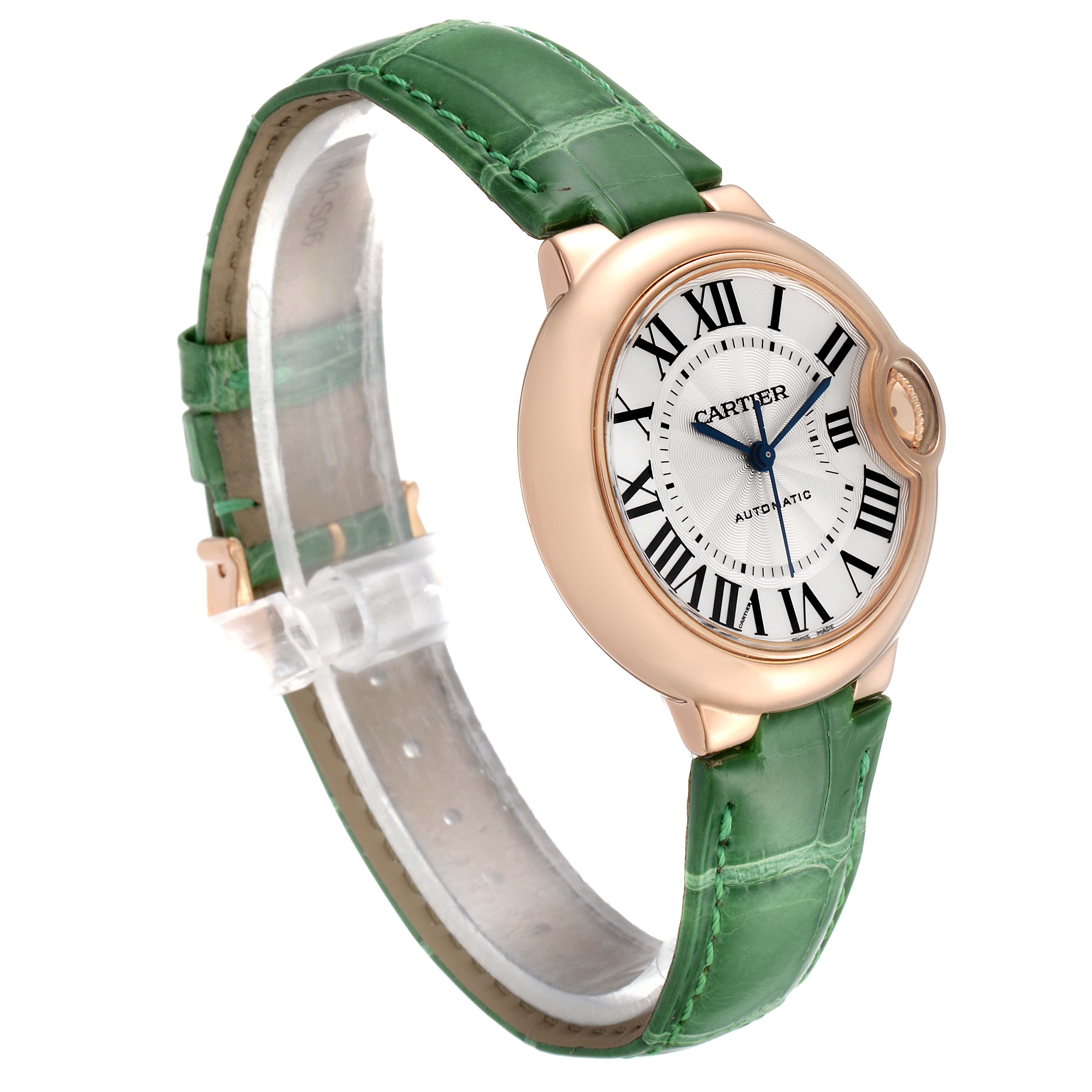The Cartier Ballon Bleu W6920097 Women's Rose Gold Silver Dial W6920097 Women's Rose Gold Silver Dial watch is shown at an angle highlighting the face, rose gold case, and green leather strap.
