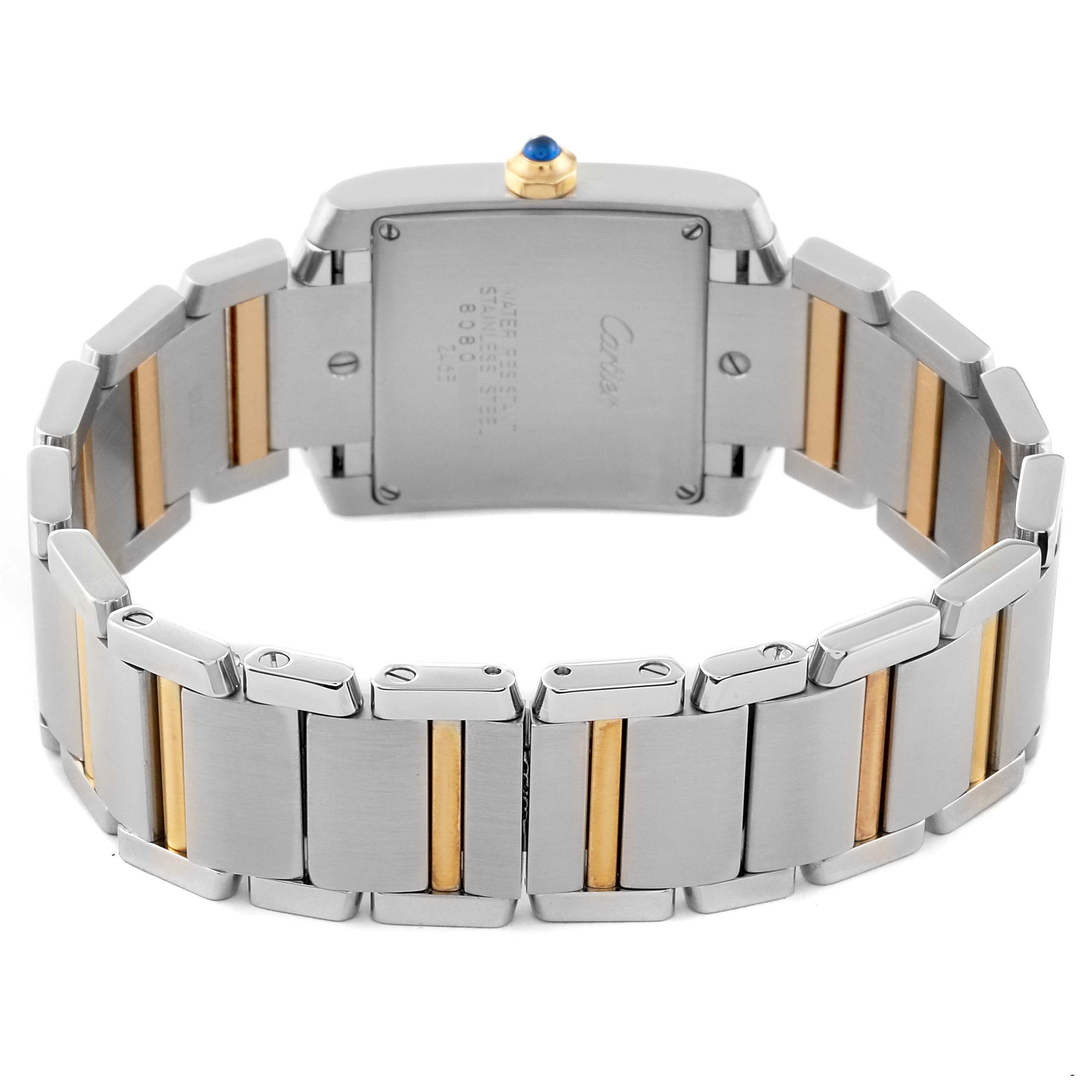 The image shows the back view of a Cartier Tank Française watch, highlighting its stainless steel and gold bracelet.