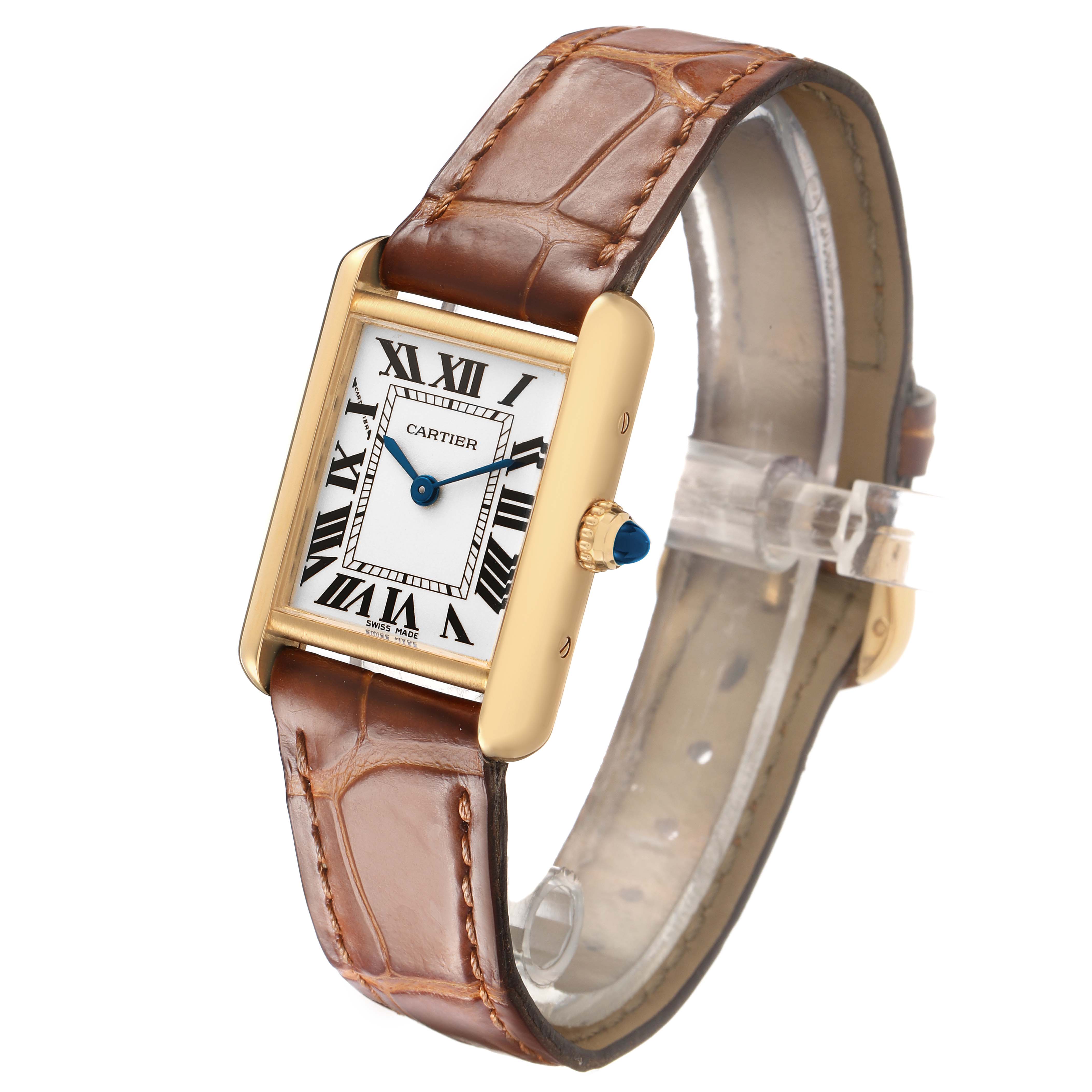 The Cartier Tank Louis W1529856 Women's Yellow Gold Silver Dial watch is shown at a slight angle, highlighting its rectangular face, Roman numerals, and leather strap.