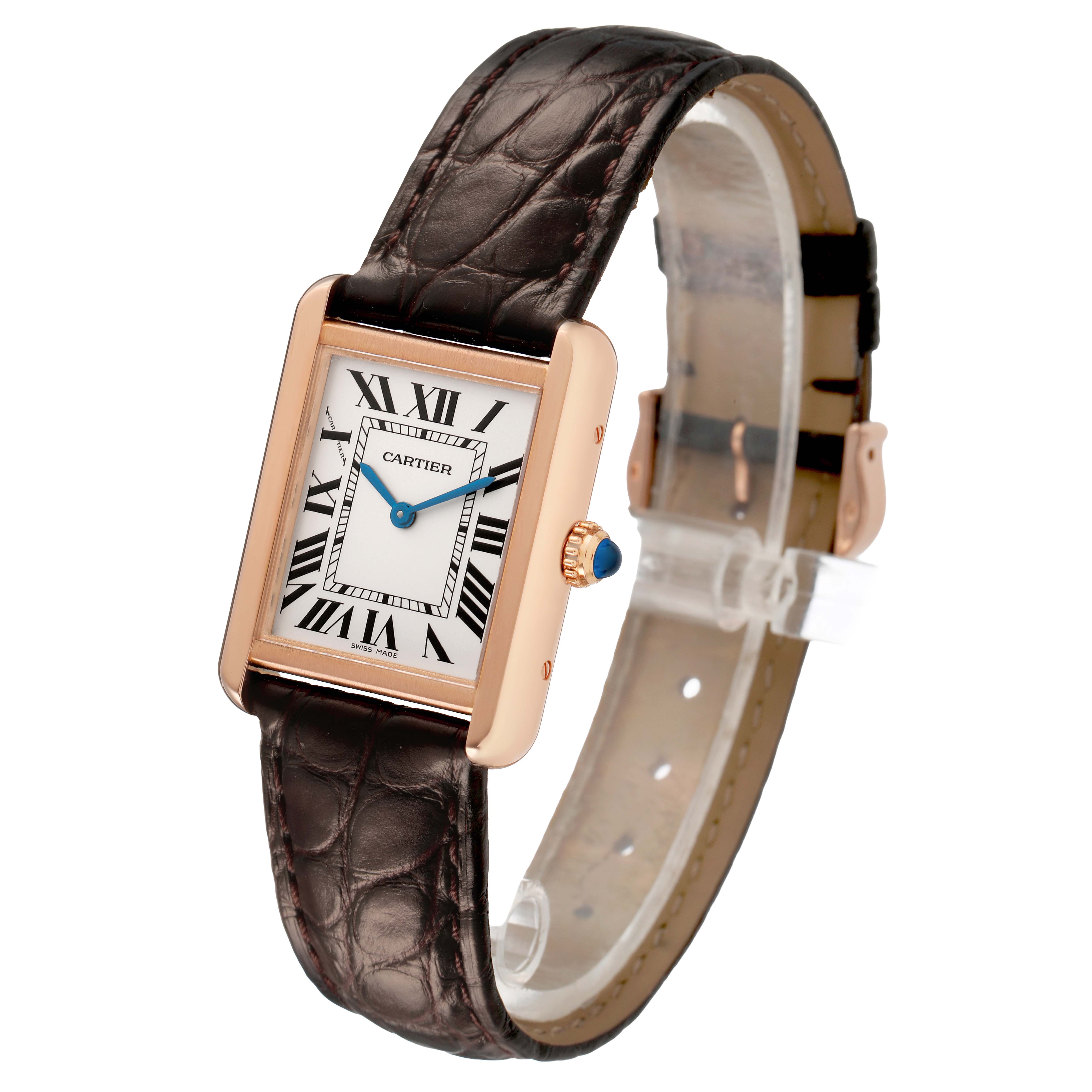 The Cartier Tank Solo W5200024 Women's Rose Gold Silver Dial watch is shown at an angled view, displaying the face, Roman numerals, blue hands, and leather strap.