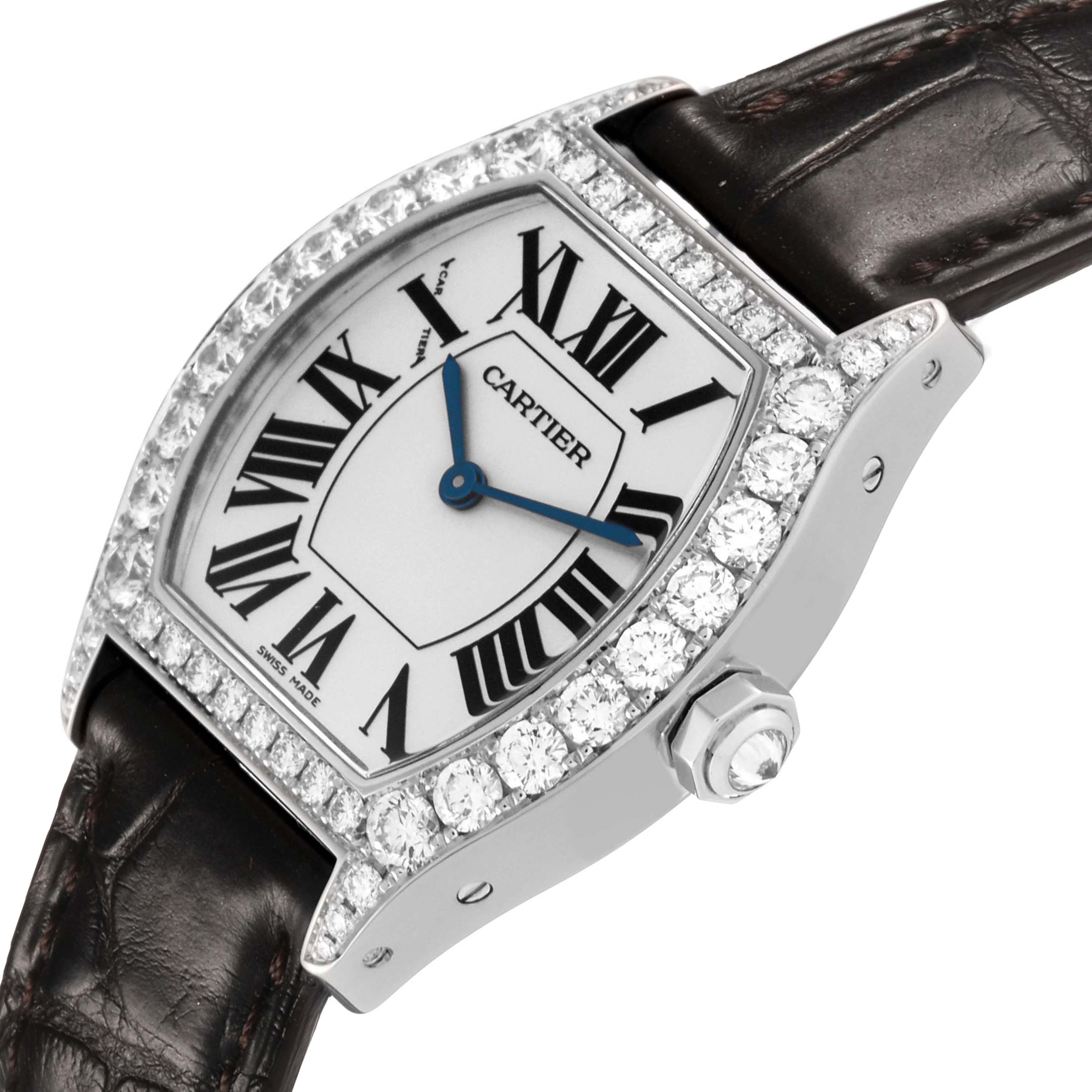 The Cartier Tortue WA507231 Women's White Gold Silver Dial watch is shown at an angle displaying its face, diamond-encrusted bezel, crown, and part of the leather strap.