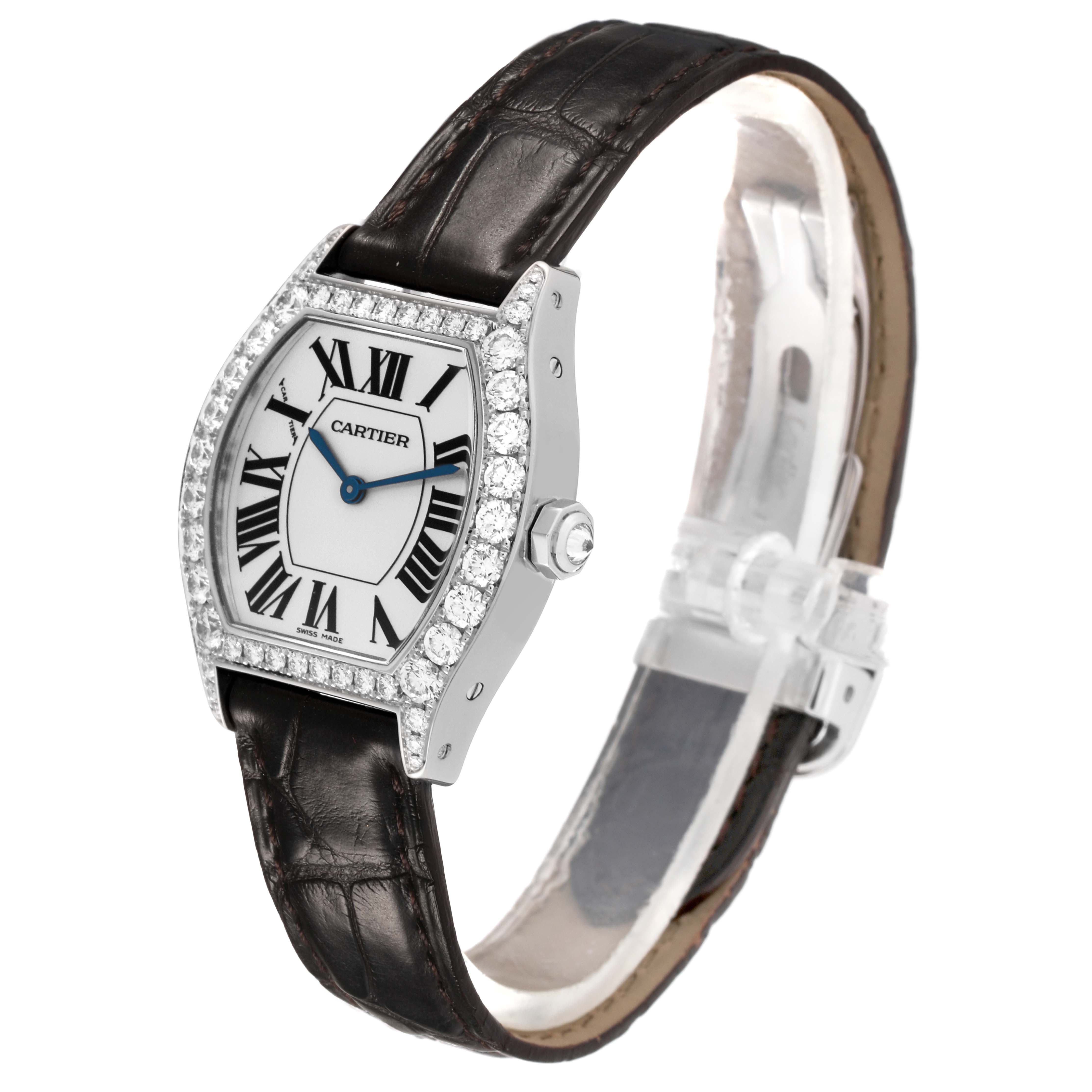 The Cartier Tortue WA507231 Women's White Gold Silver Dial watch is shown at a three-quarter angle, highlighting its case, diamond bezel, dial, and leather strap.