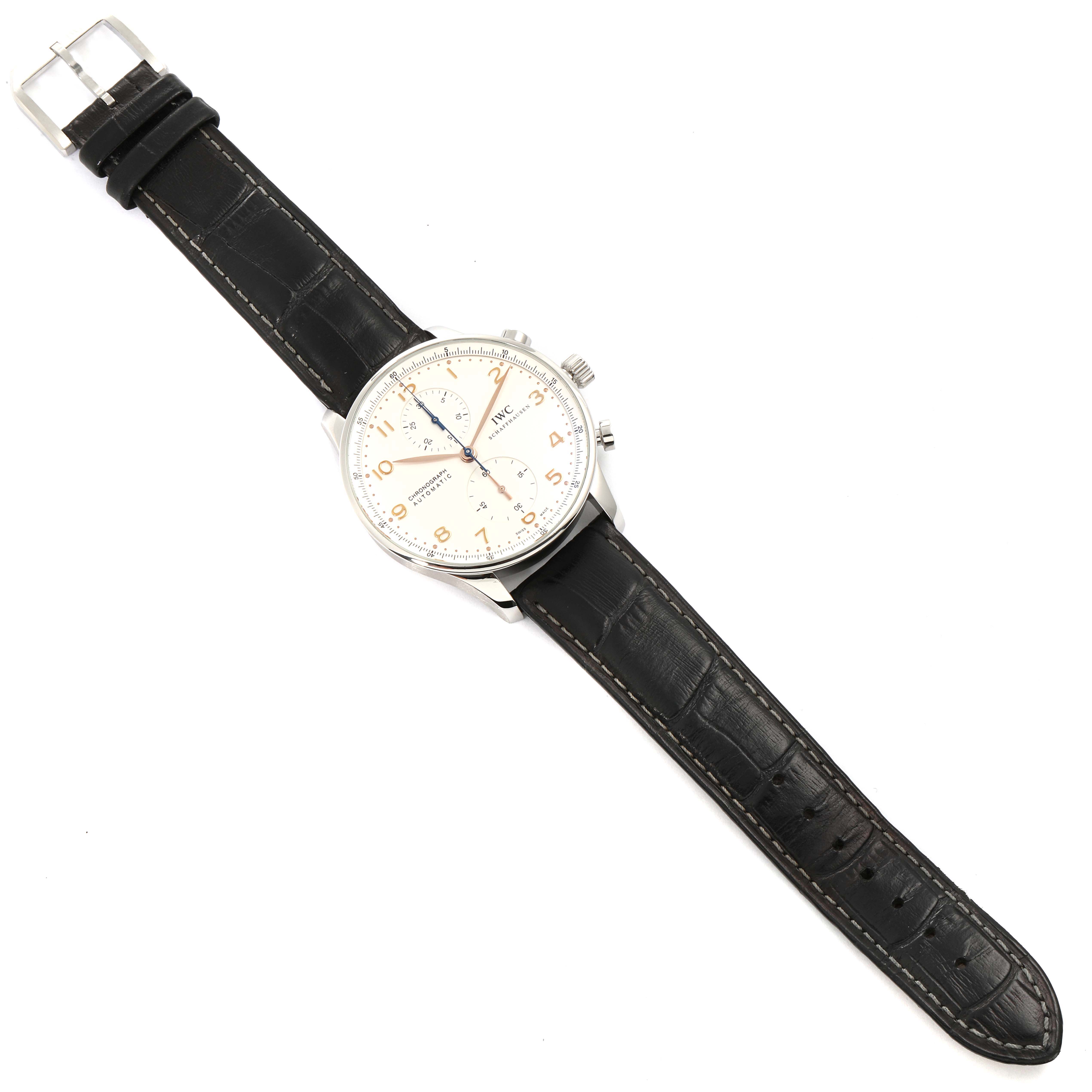 The image shows an IWC Portuguese IW371445 Men's Stainless Steel Silver Dial IW371445 Men's Stainless Steel Silver Dial model watch with a black leather strap, silver case, and white dial, displayed from a top-down angle.