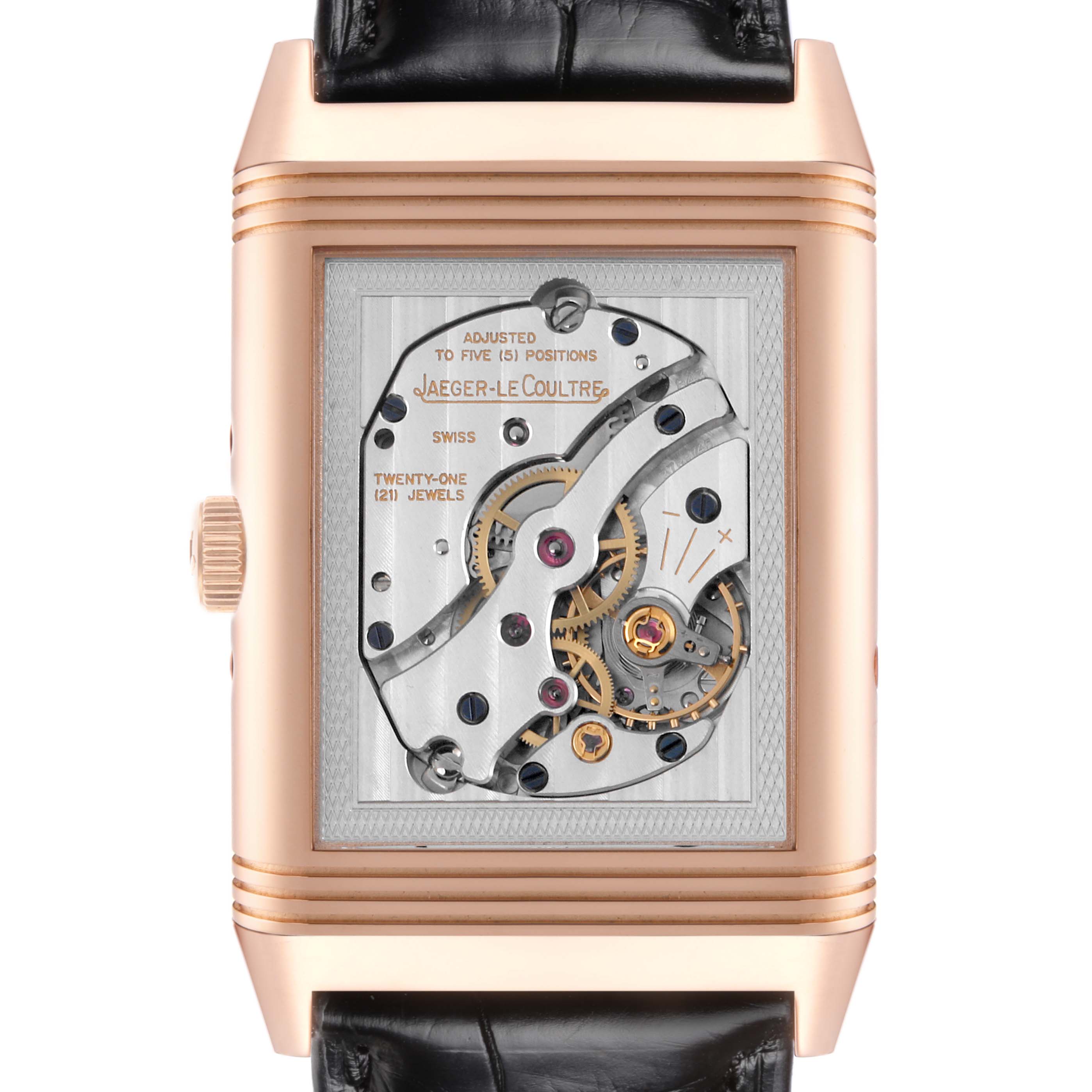 The image shows the back view of a Jaeger-LeCoultre Reverso, highlighting its intricate mechanical movement.